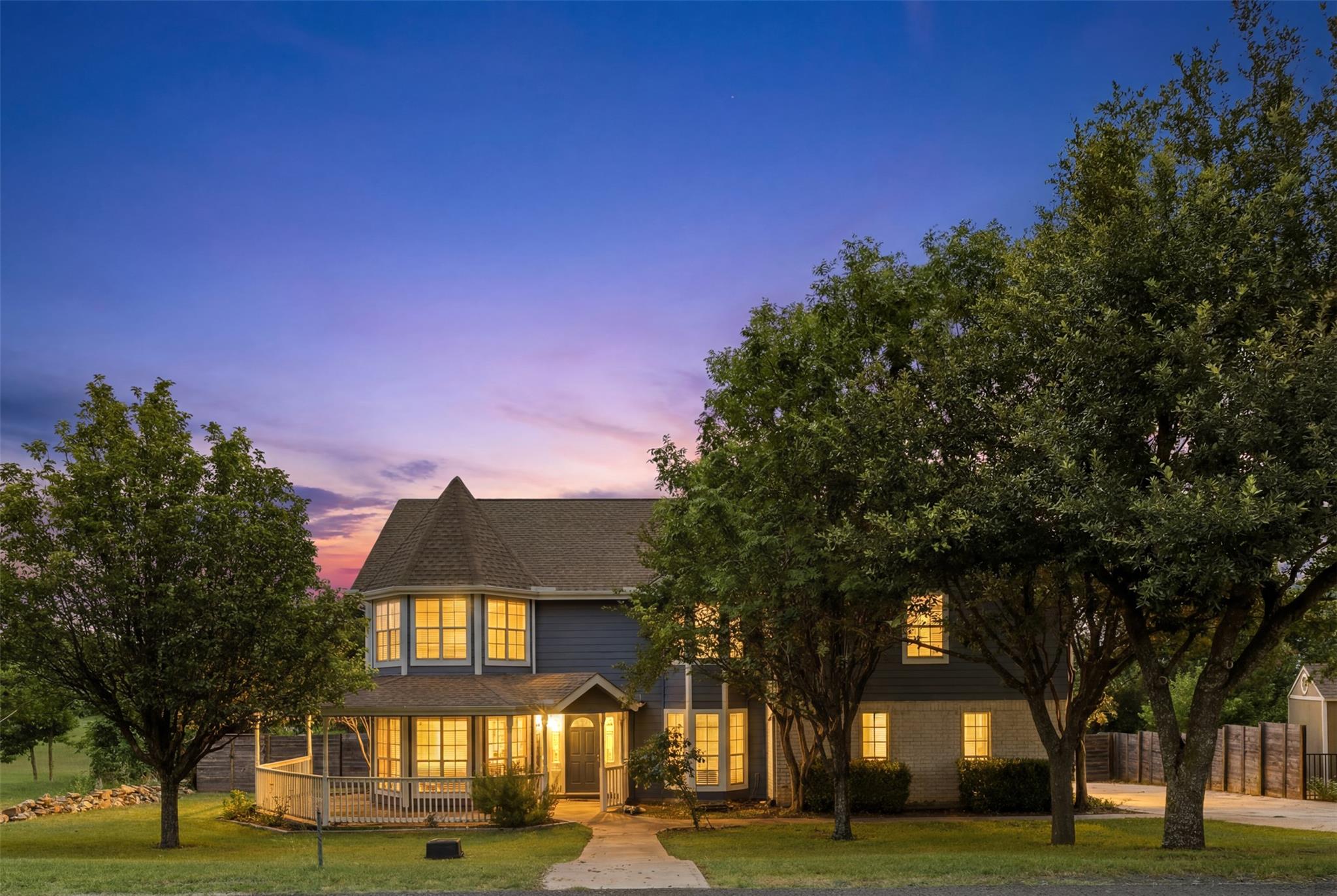A welcoming abode with a wraparound porch and bri