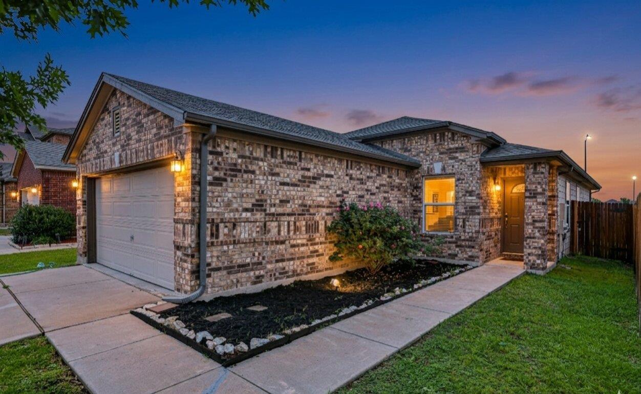 Brick exterior featuring a covered entry and an a