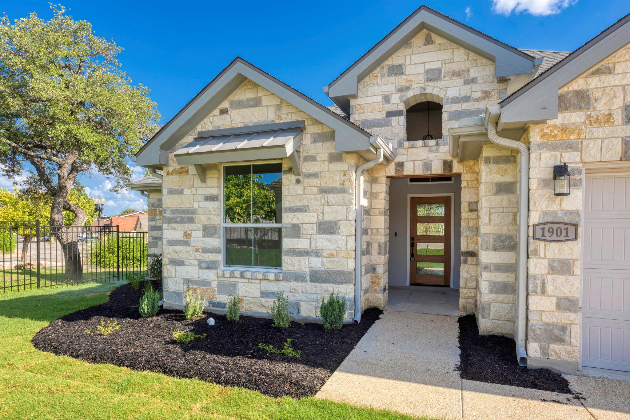 Stone veneer exterior featuring a covered entry, 