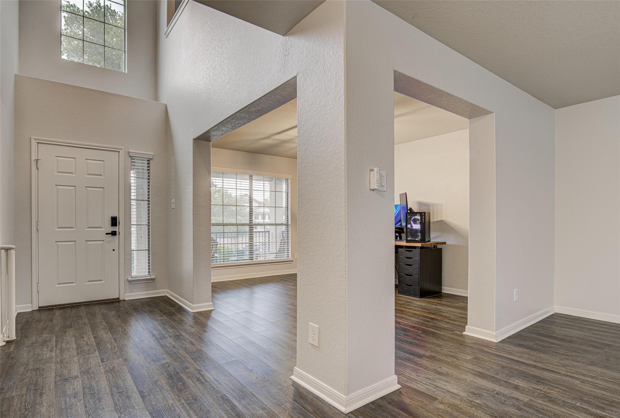 Entry foyer featuring wood-finish flooring, a con