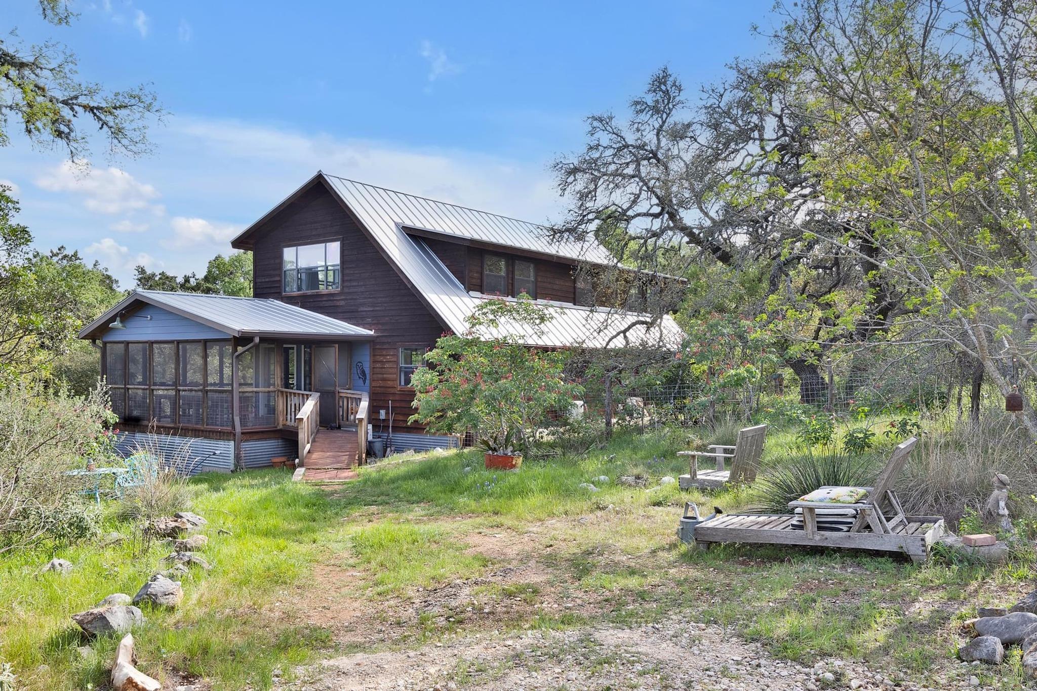 Two-story residence featuring a dark wood exterio