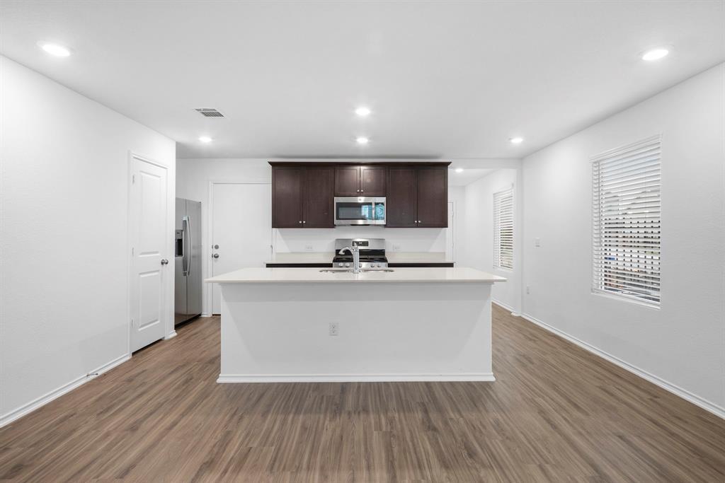 Open-concept kitchen featuring an island with a s