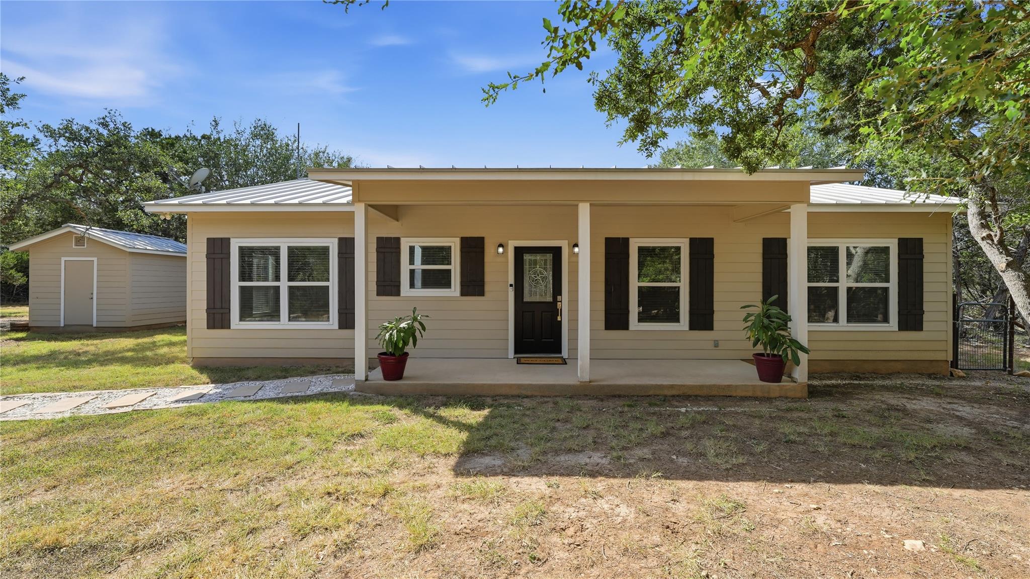 Shuttered windows and a covered front porch creat