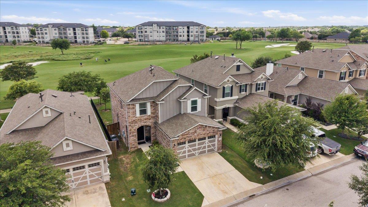 Two-story residence featuring a brick facade with