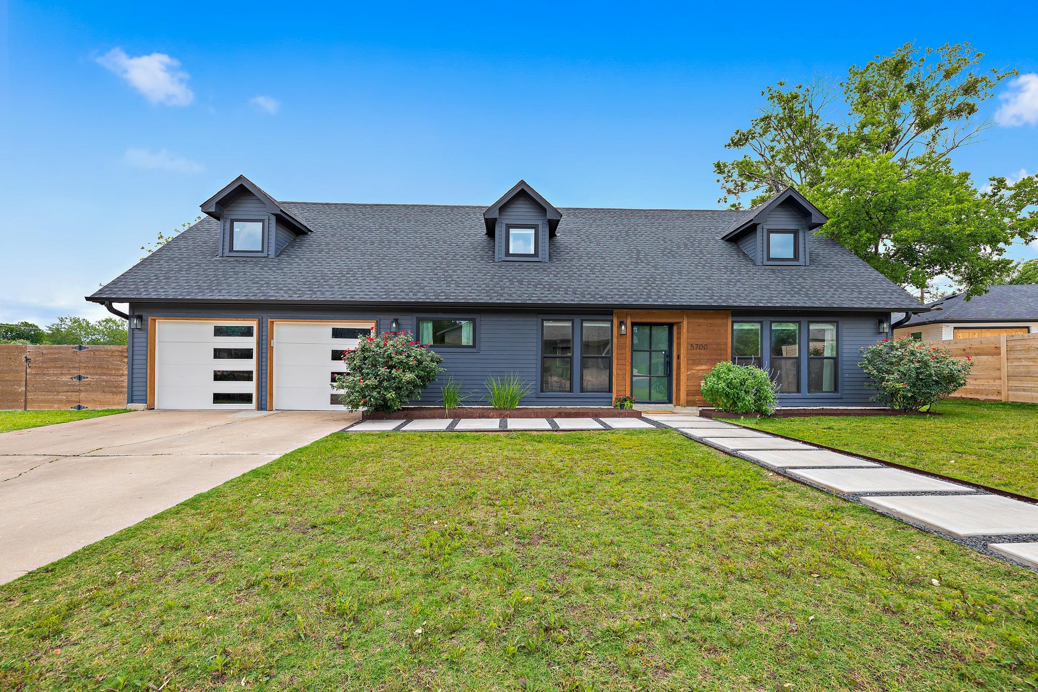 Contemporary-style home featuring a dark gray fac