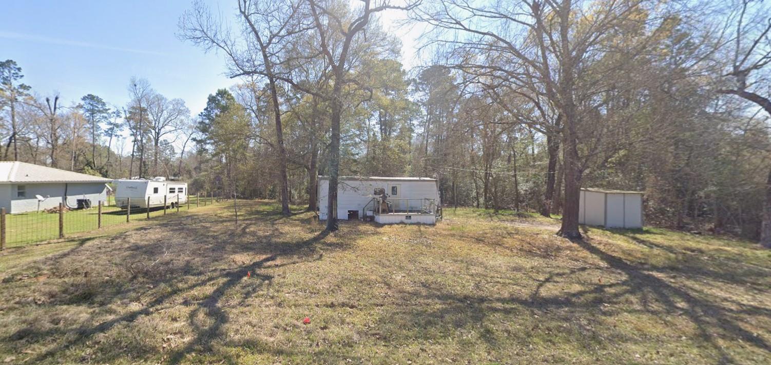A spacious, wooded lot offers ample privacy for m