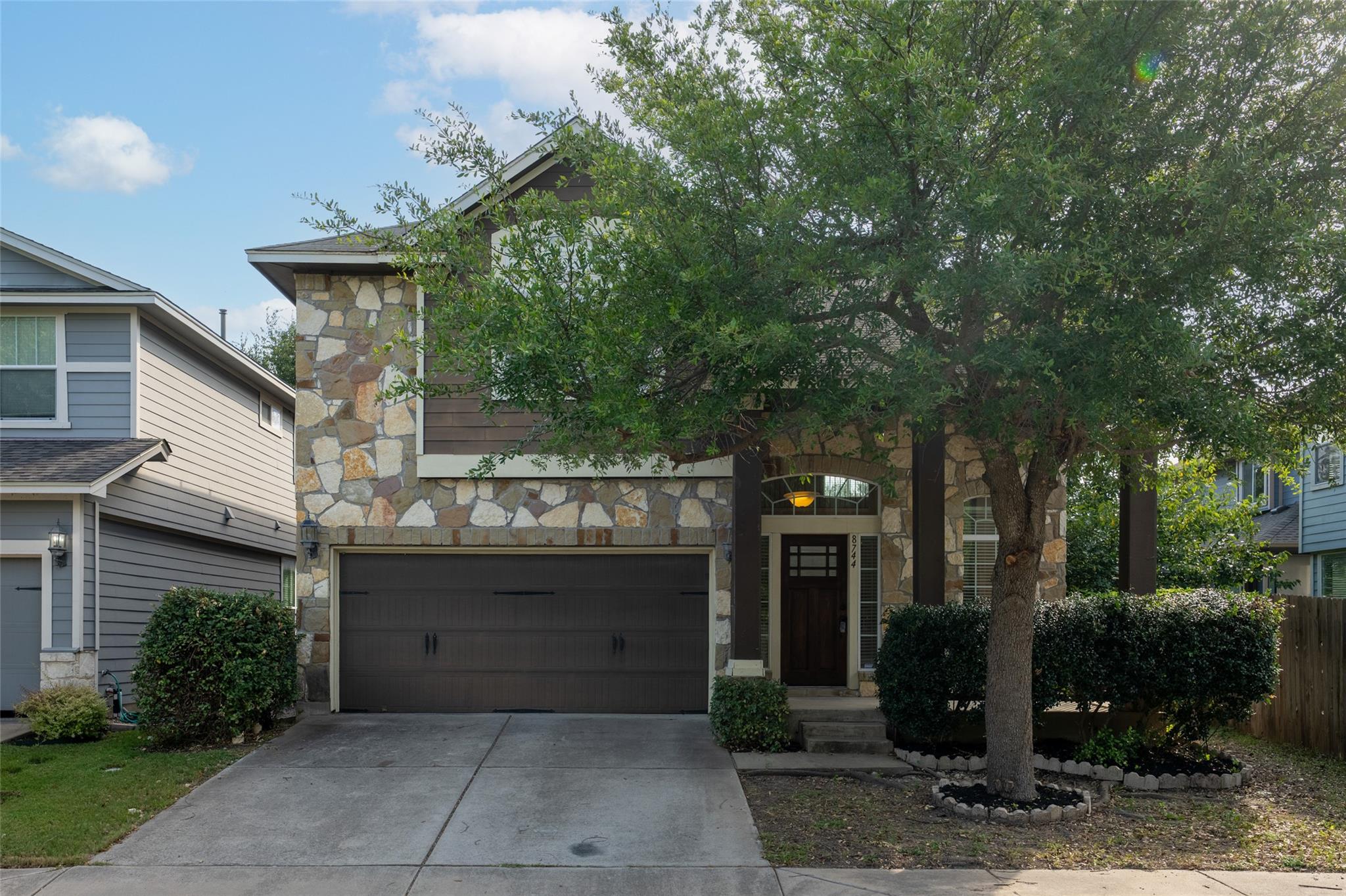 A charming exterior showcasing a blend of stone a