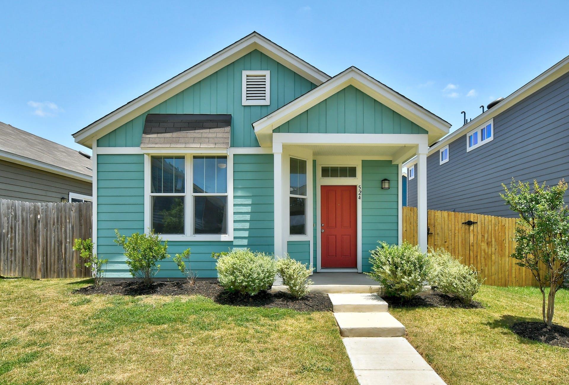 A welcoming front entry features a bold red door 