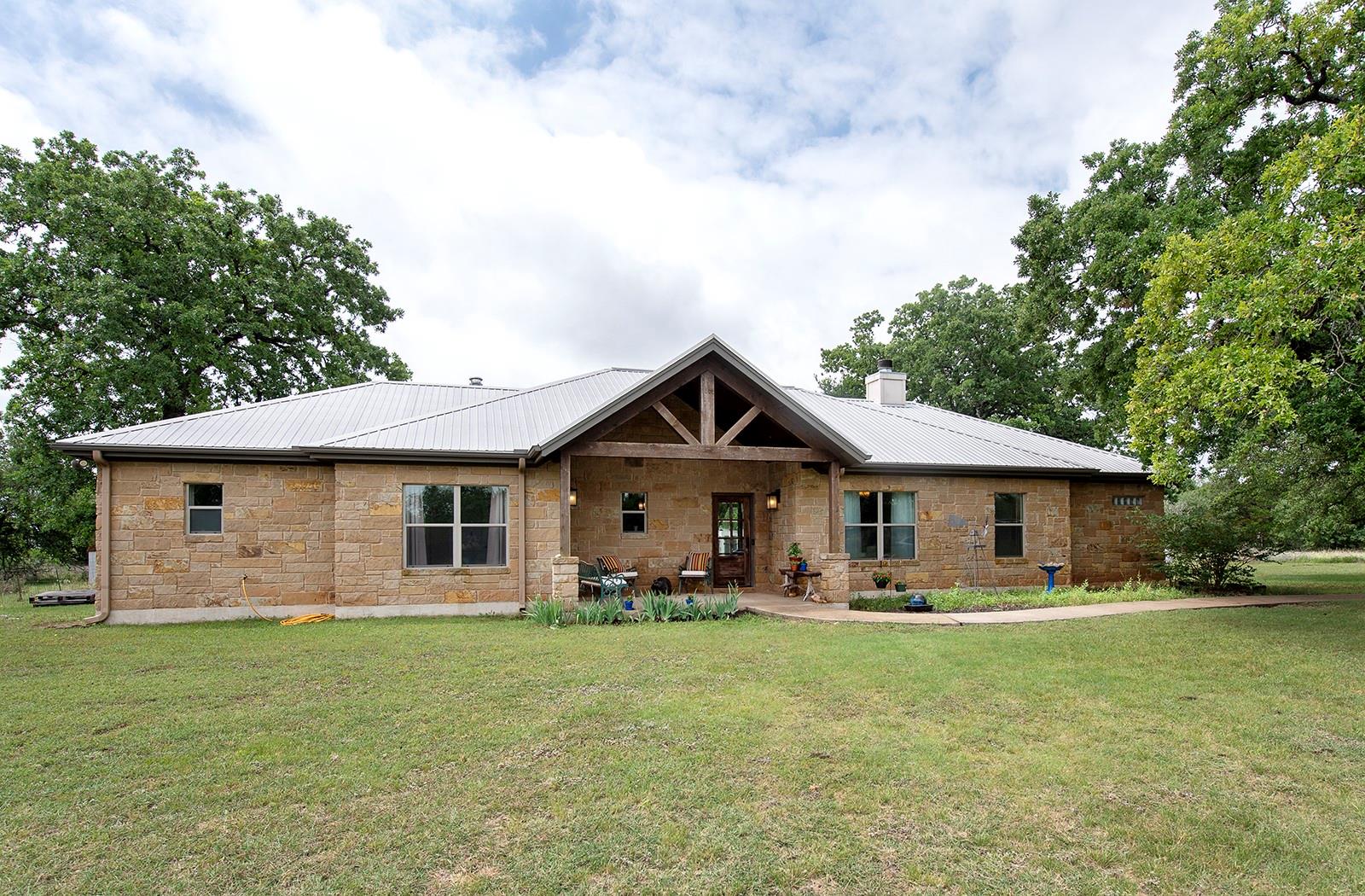 Stone exterior residence with a metal roof and an