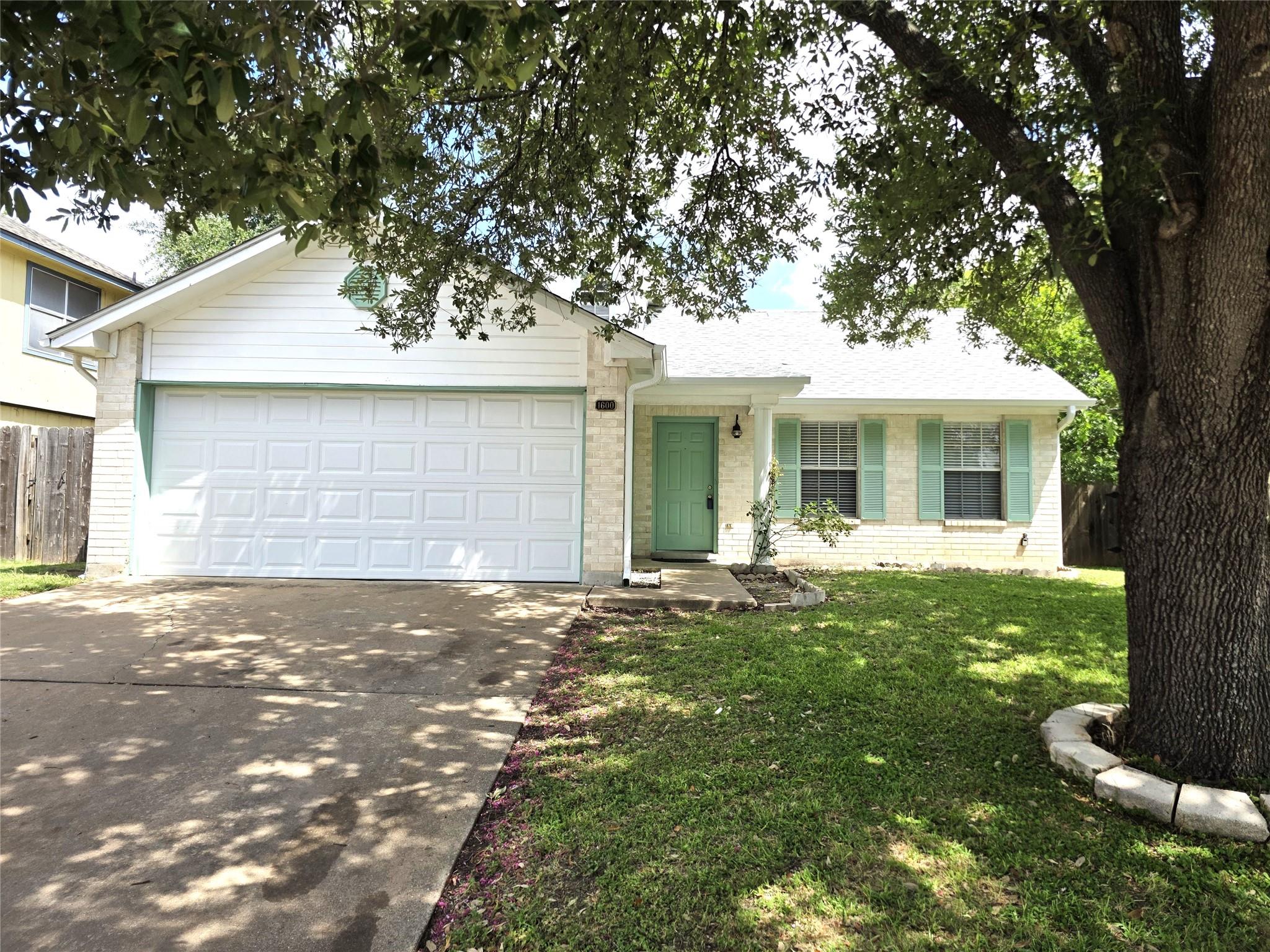 A classic ranch home features a single garage and