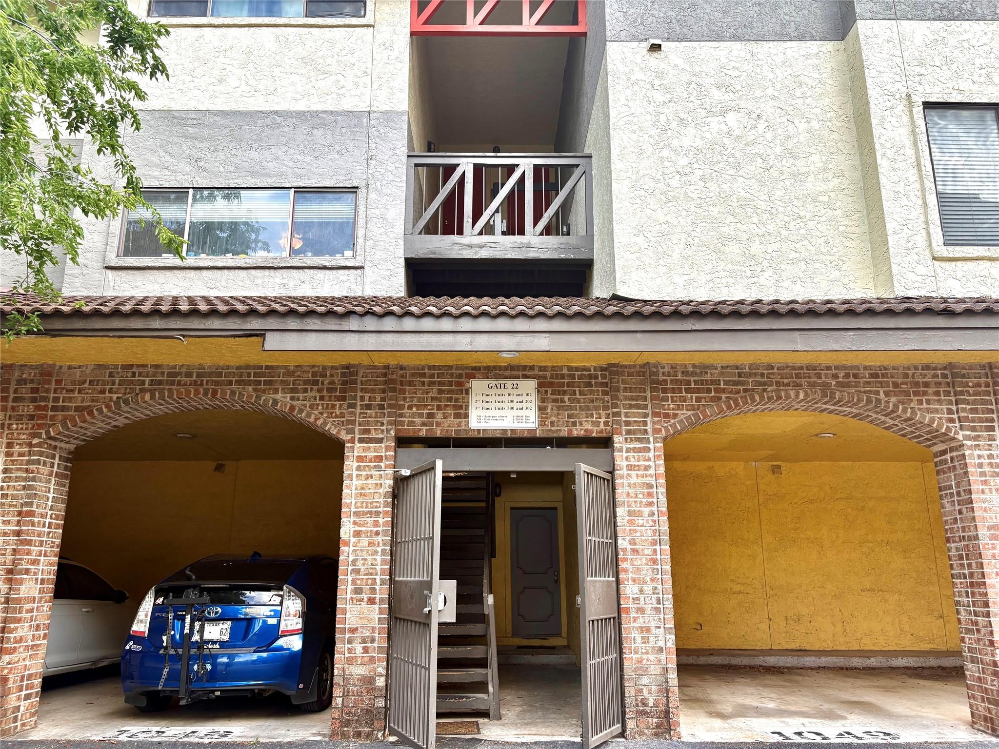 Brick facade entrance with arched parking bays an