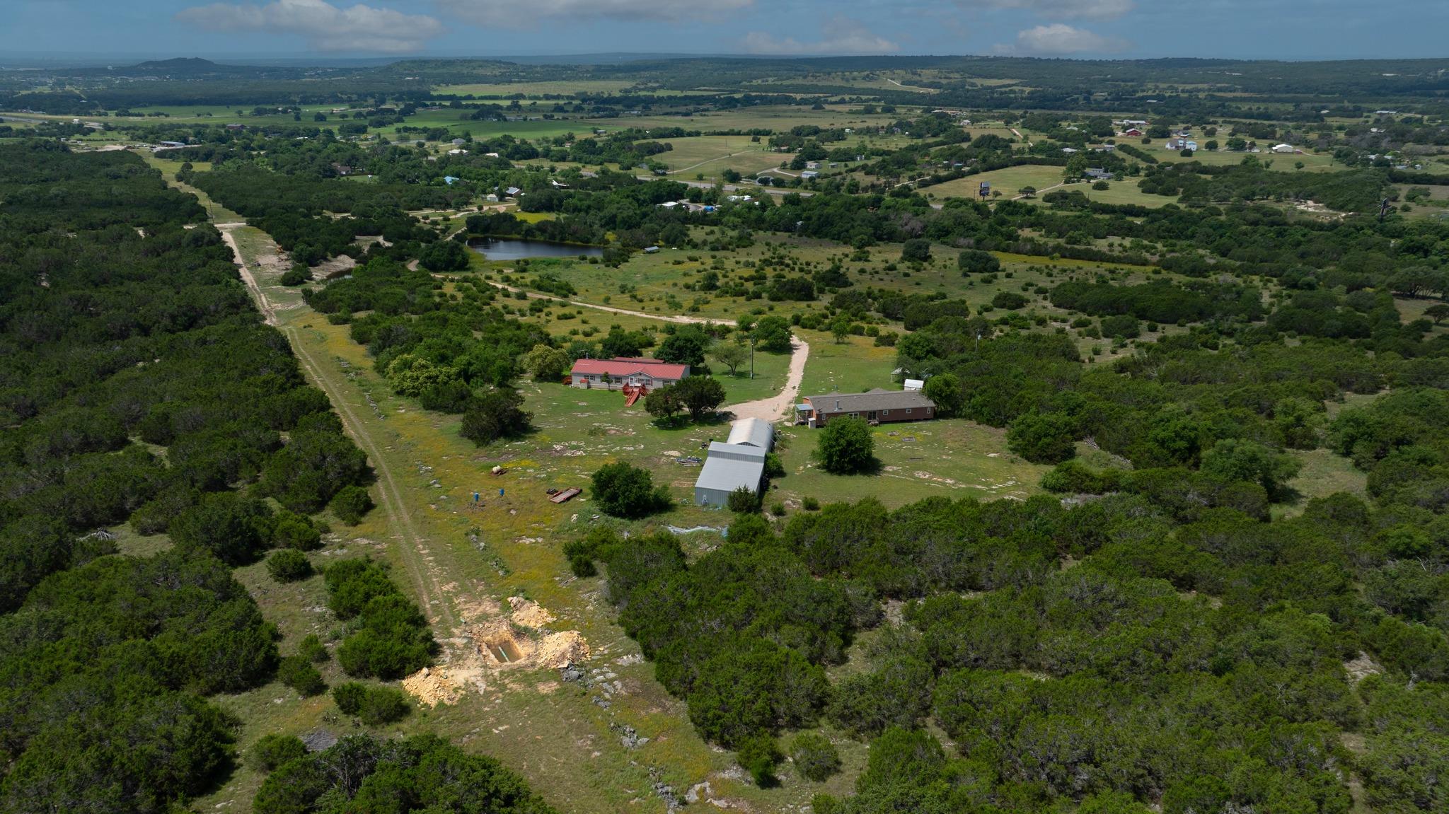 Observe this verdant acreage with private pond an