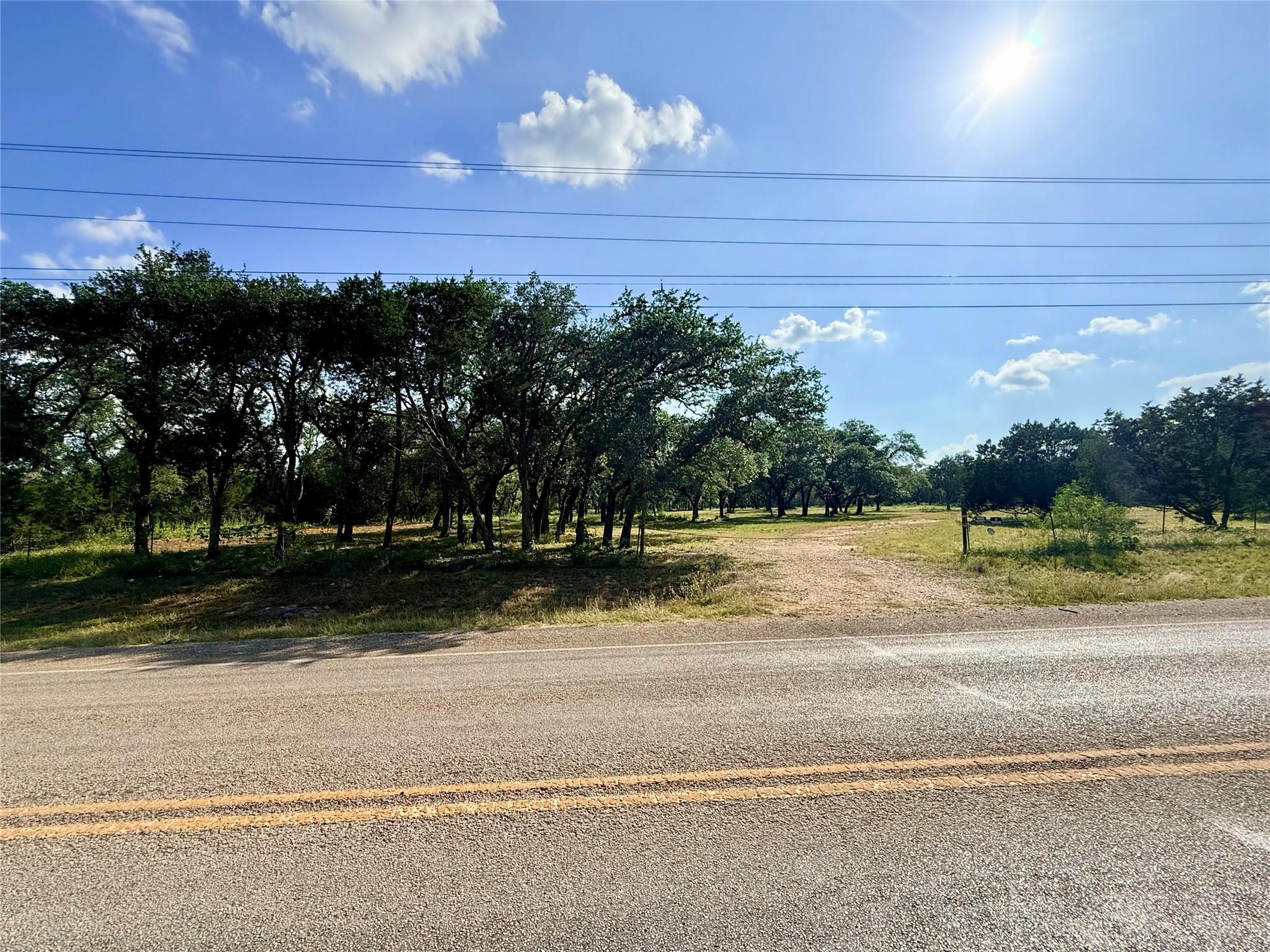 Mature trees and open land create a private, tran