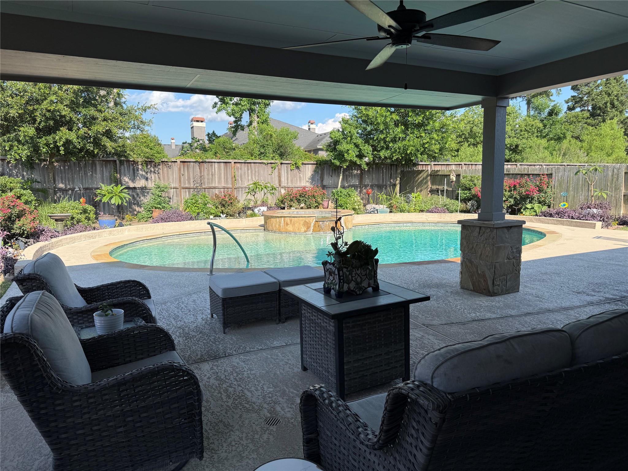 An inviting covered patio seamlessly extends to a