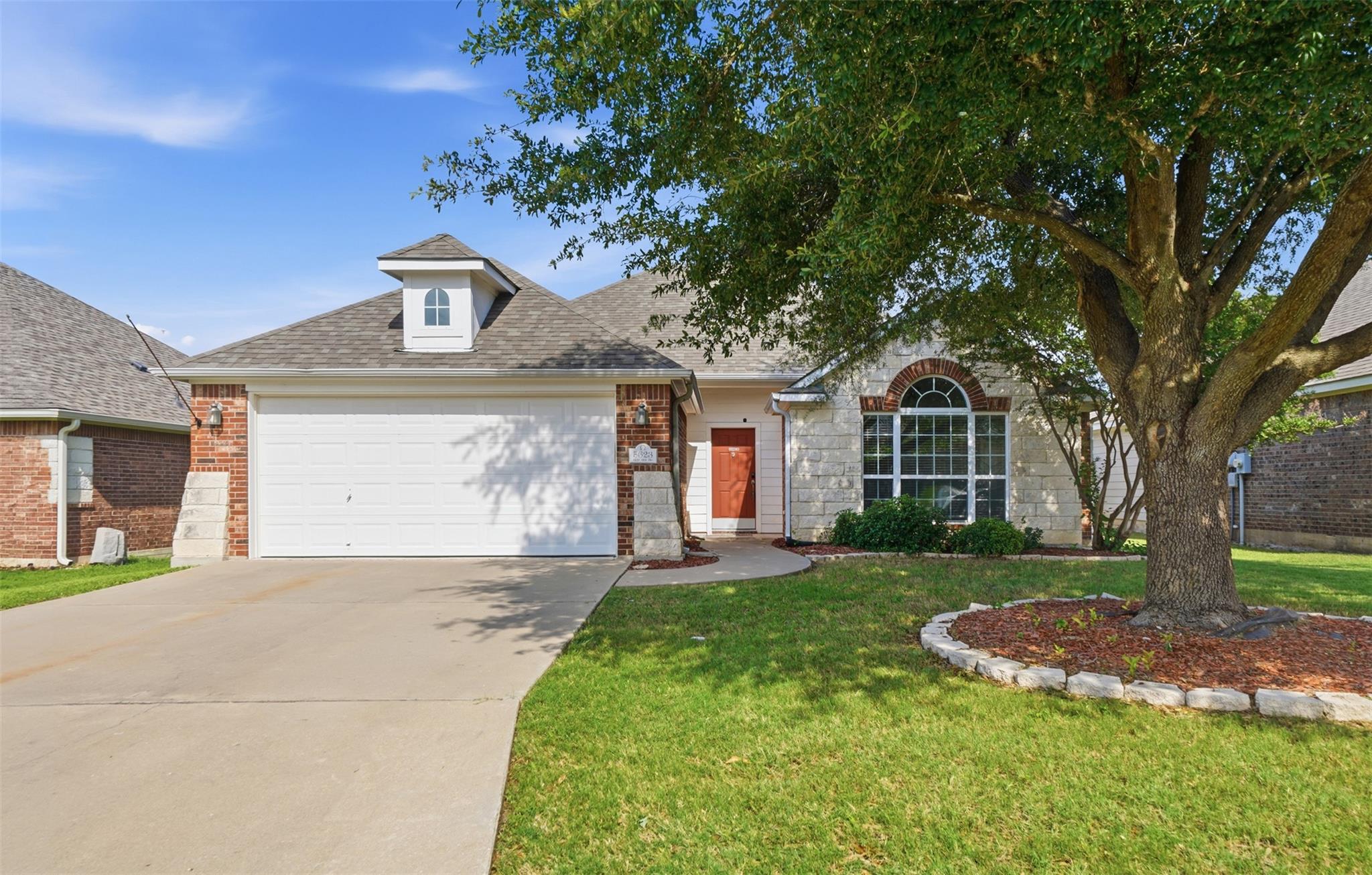 A welcoming front entry with a warm red door and 