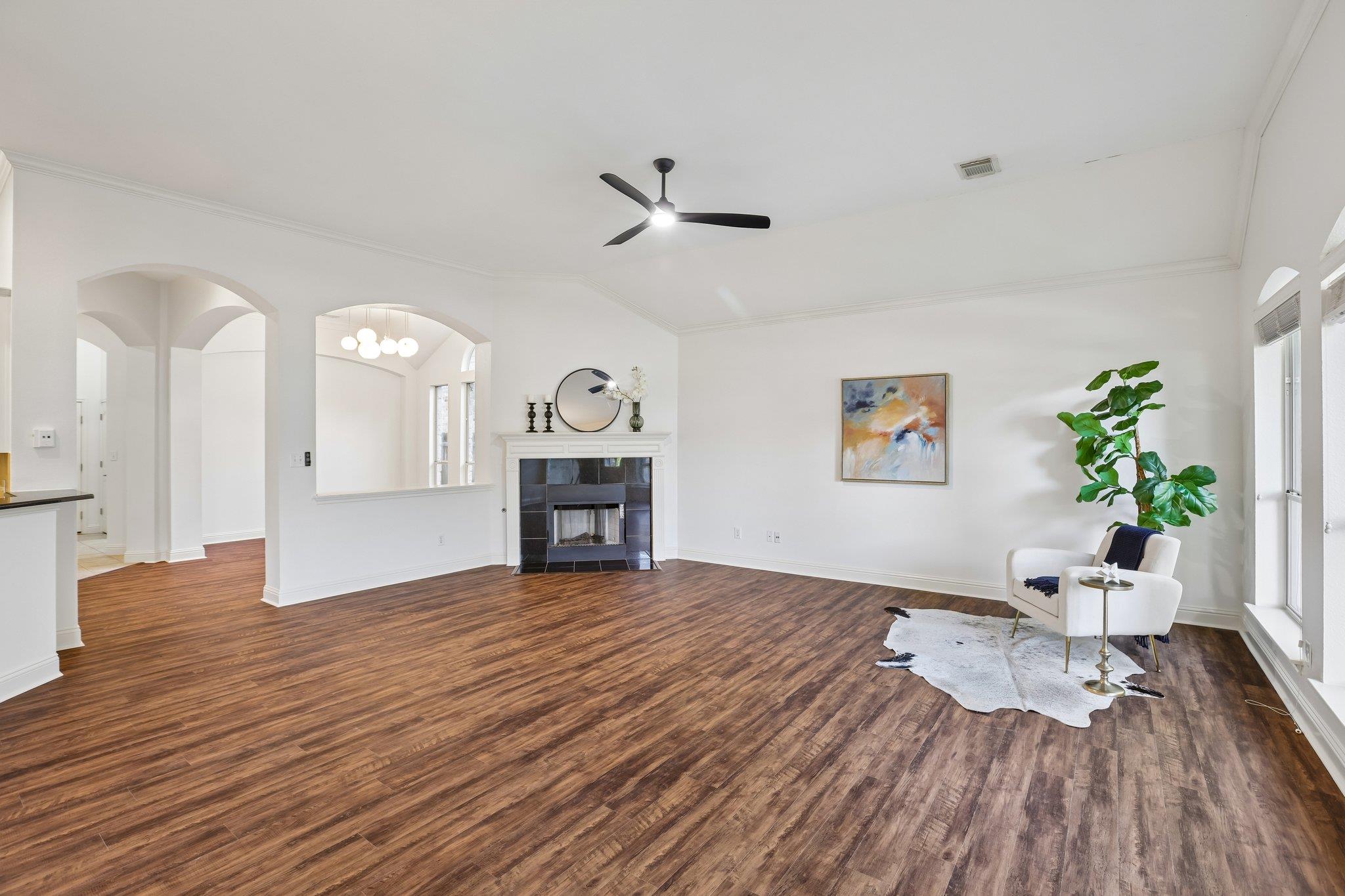 A welcoming living area boasts rich hardwood floo