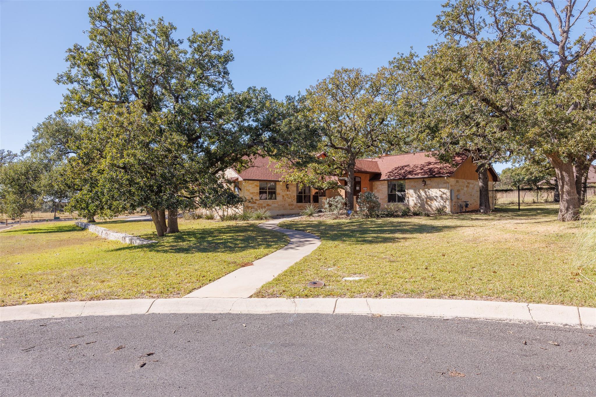 Mature trees shade this charming residence with a