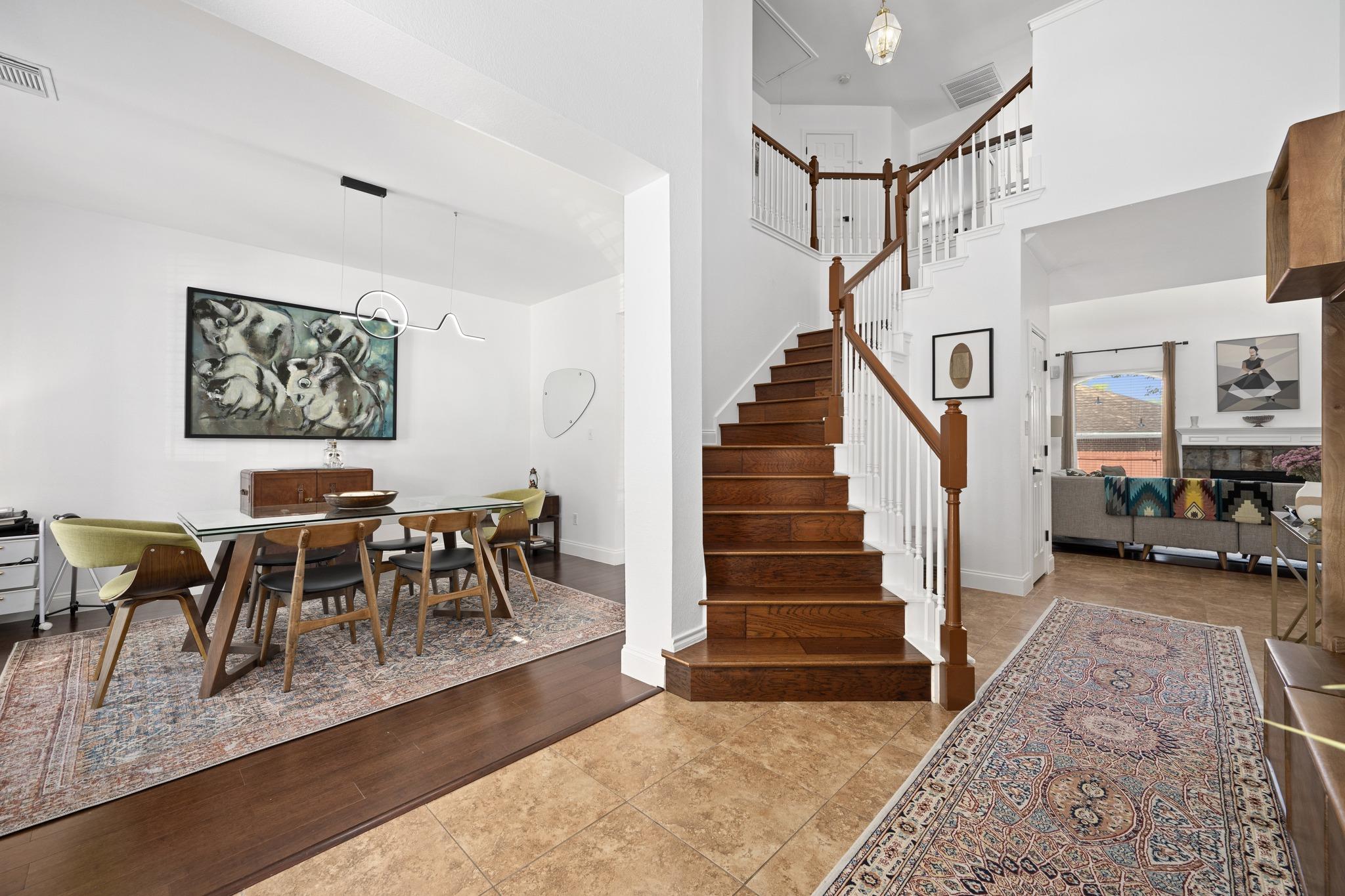 Rich hardwood stairs ascend gracefully, complemen