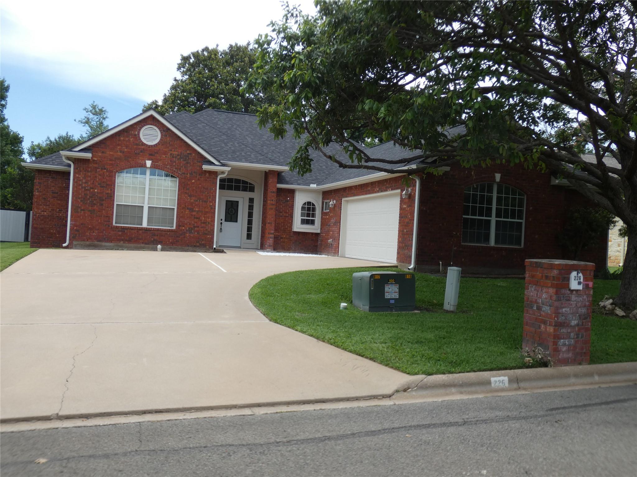 A classic brick exterior with an attached garage 