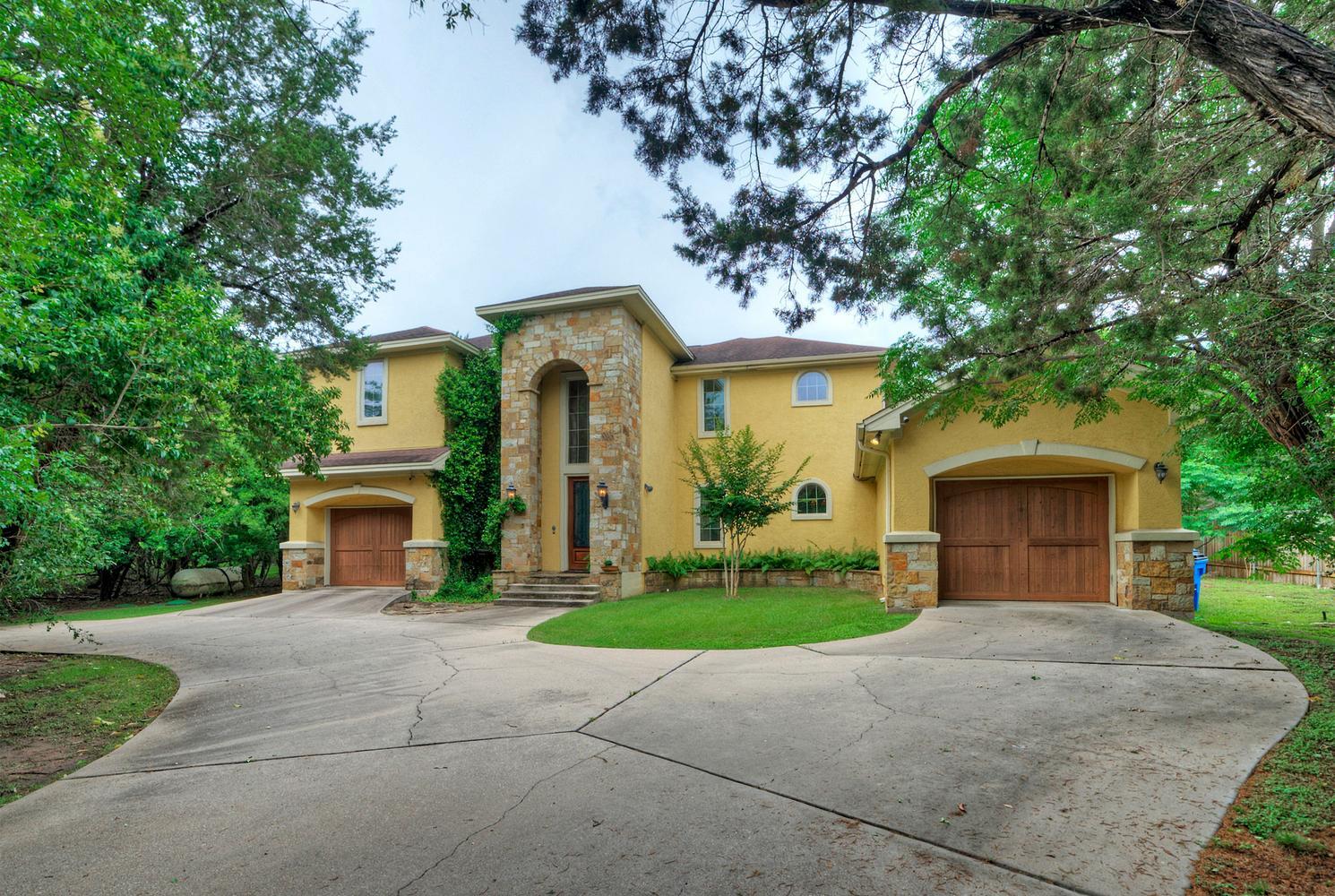 Grand stone archway and warm stucco welcome you t