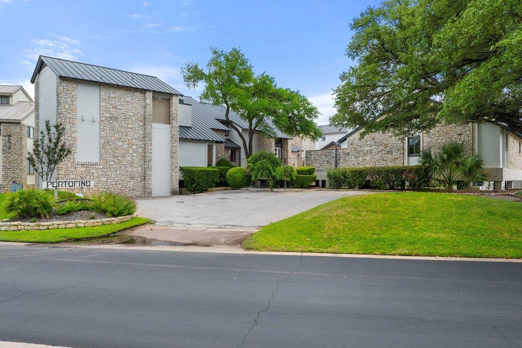 Stone exteriors and verdant landscaping create a 