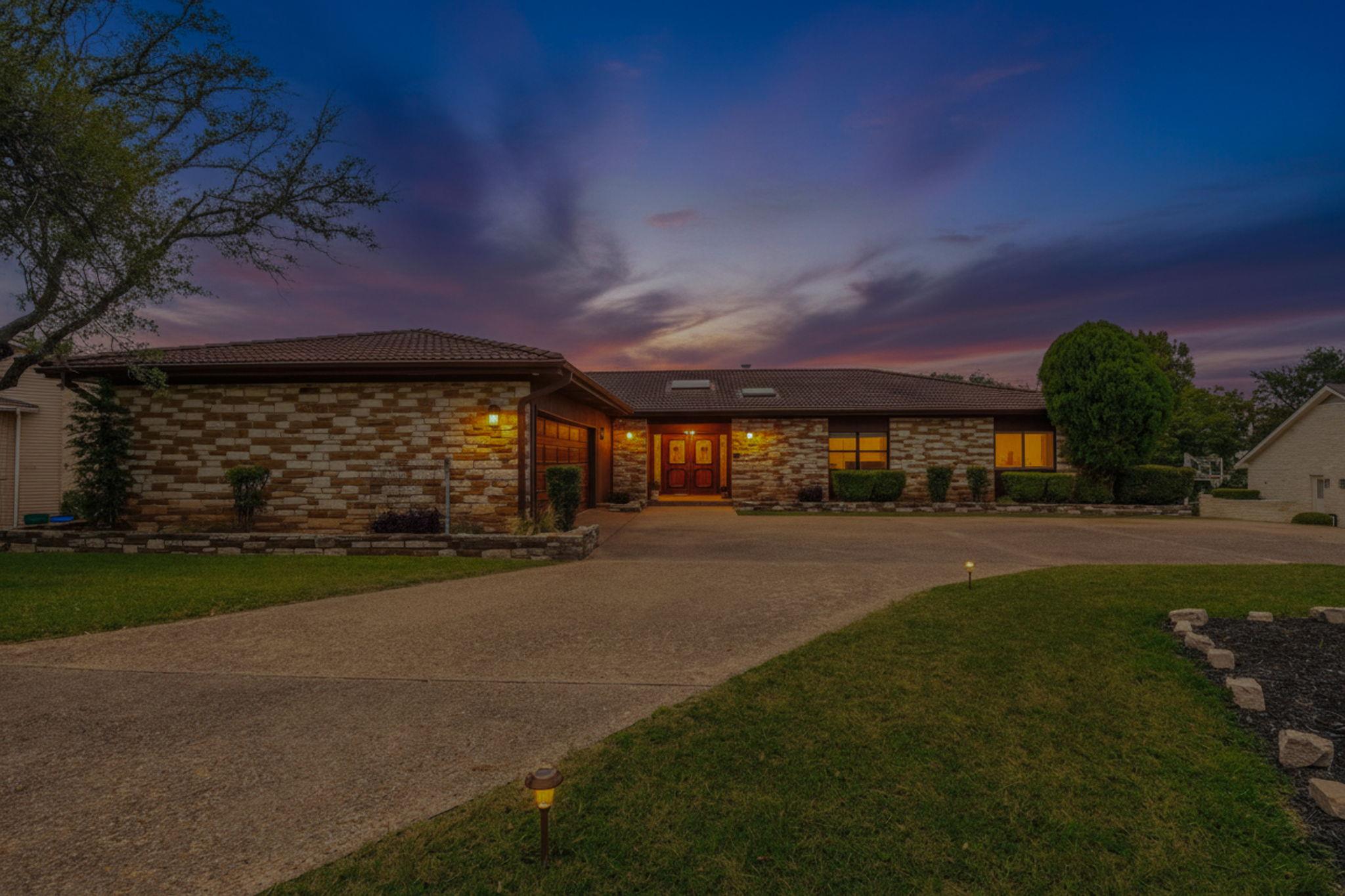 A striking exterior, featuring natural stone and 