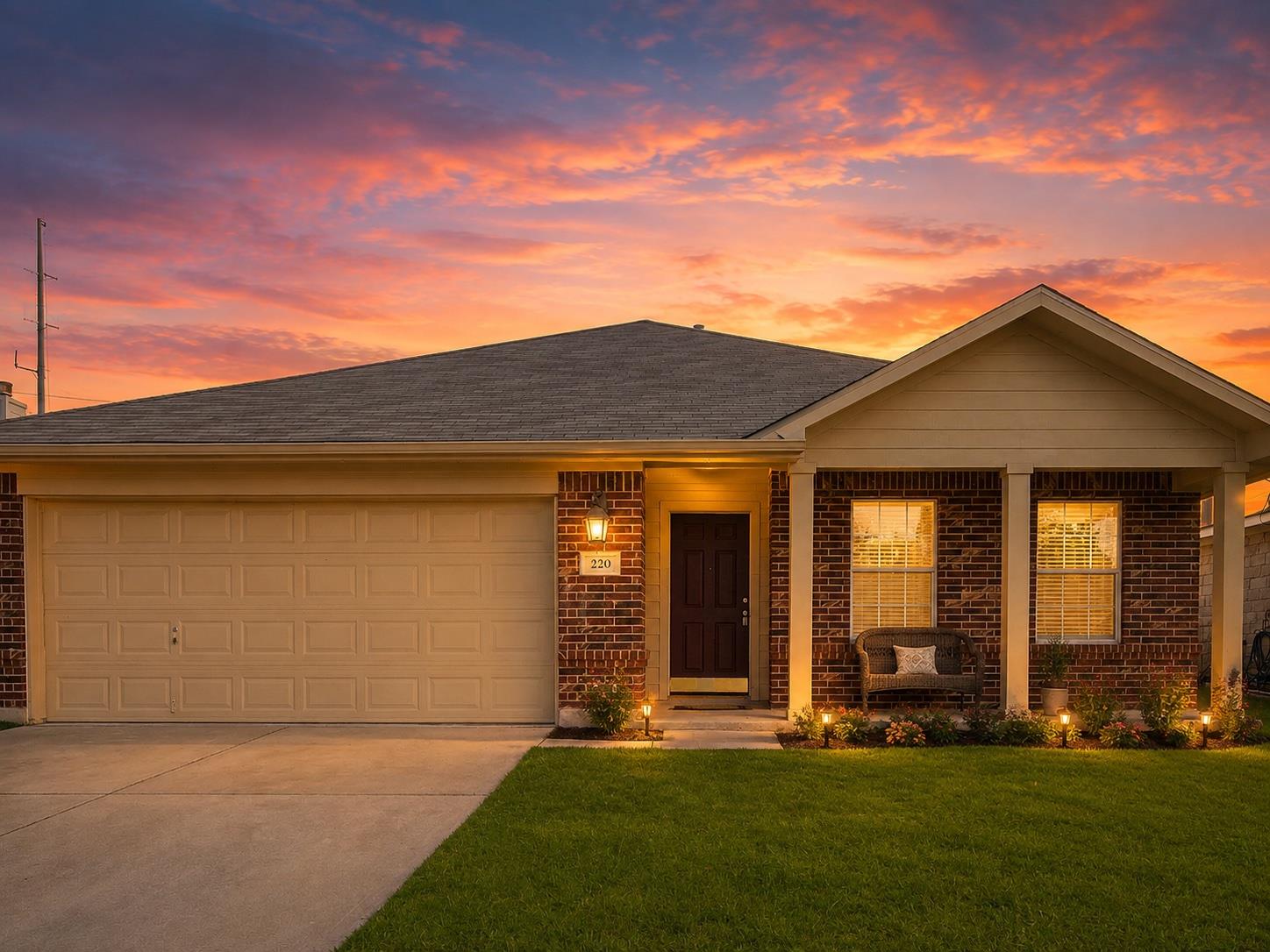 A welcoming brick facade with an attached garage 