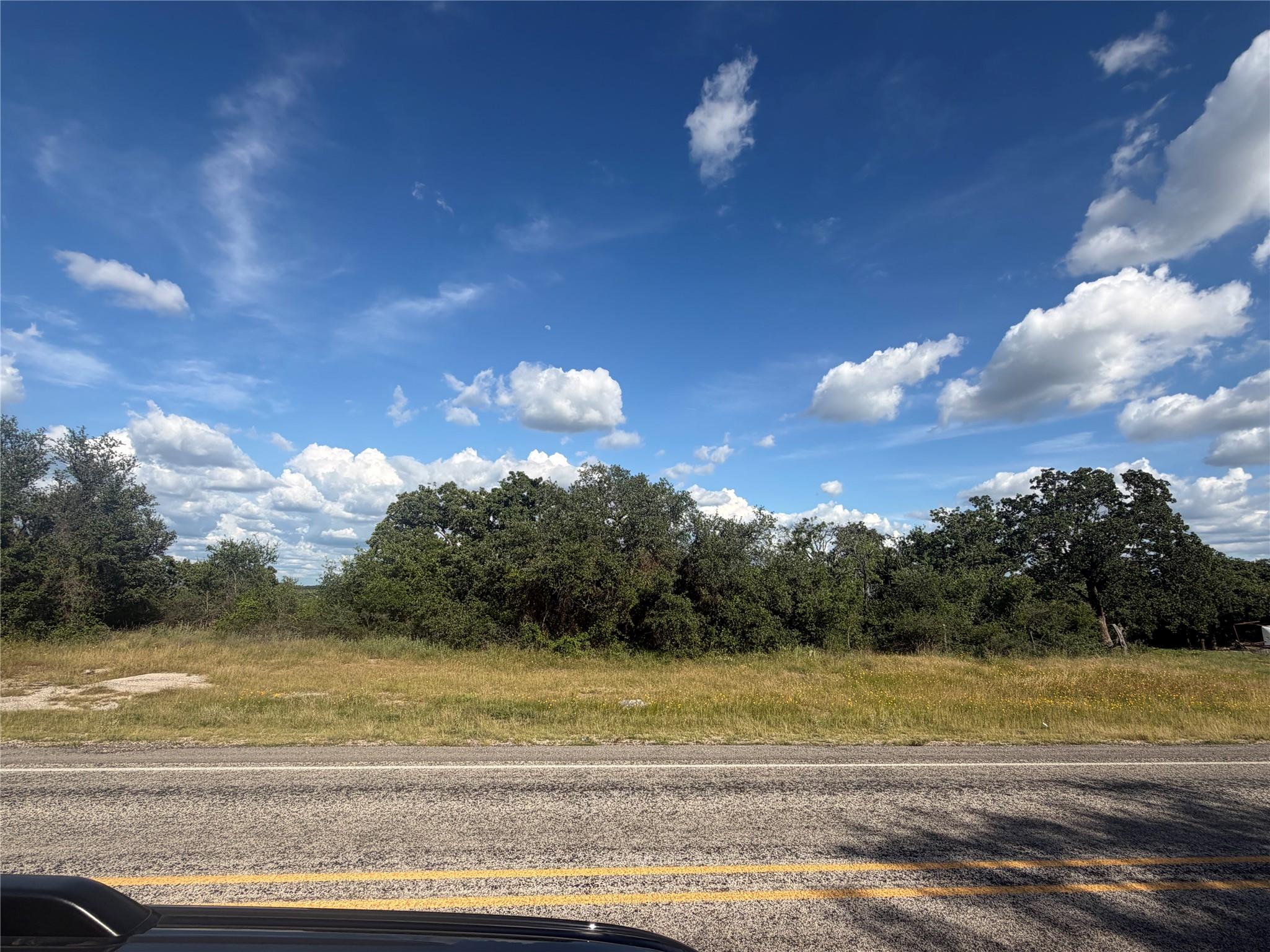A tranquil, undeveloped roadside lot offers a cle
