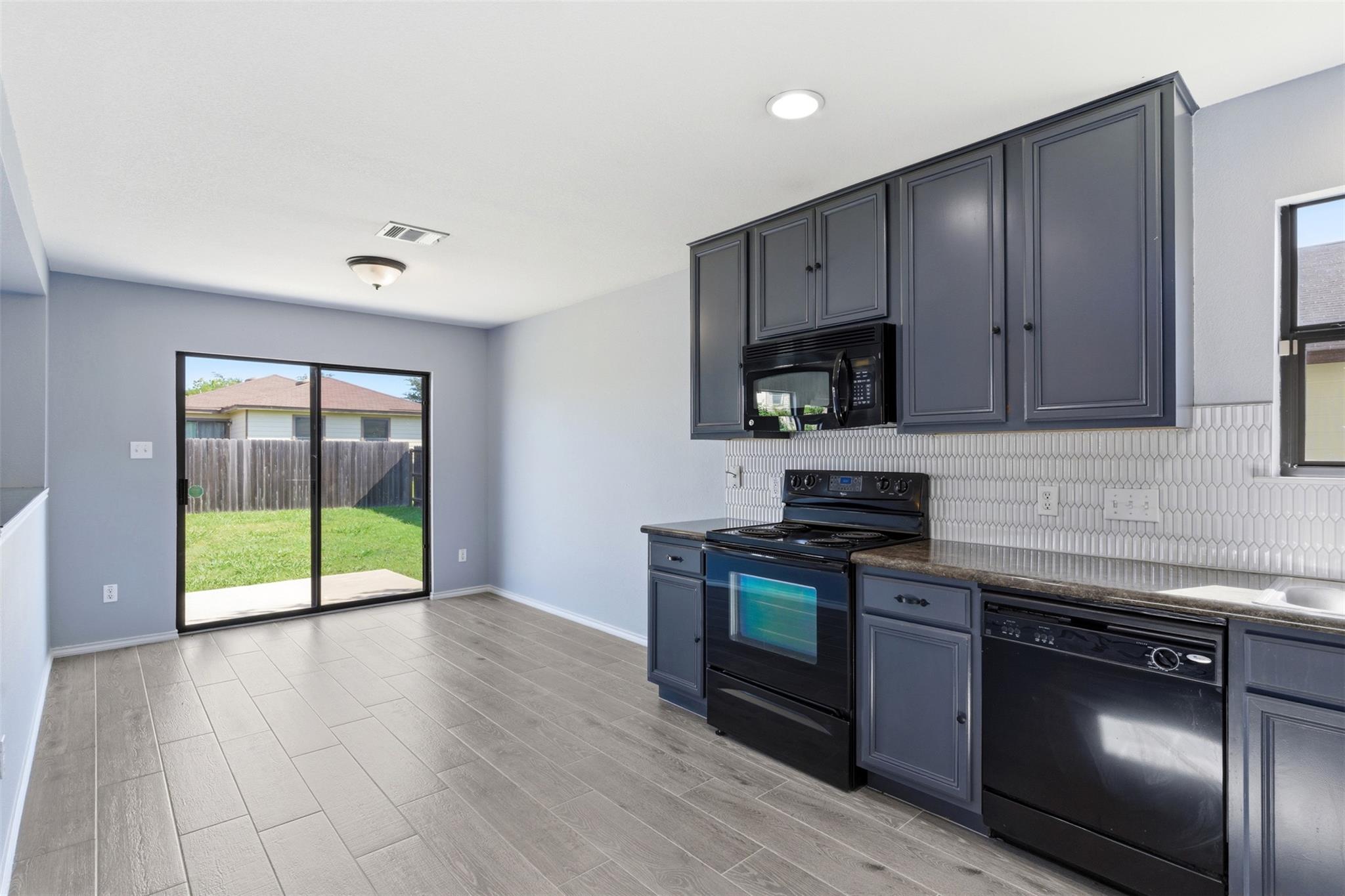 A well-appointed kitchen offers sleek appliances 