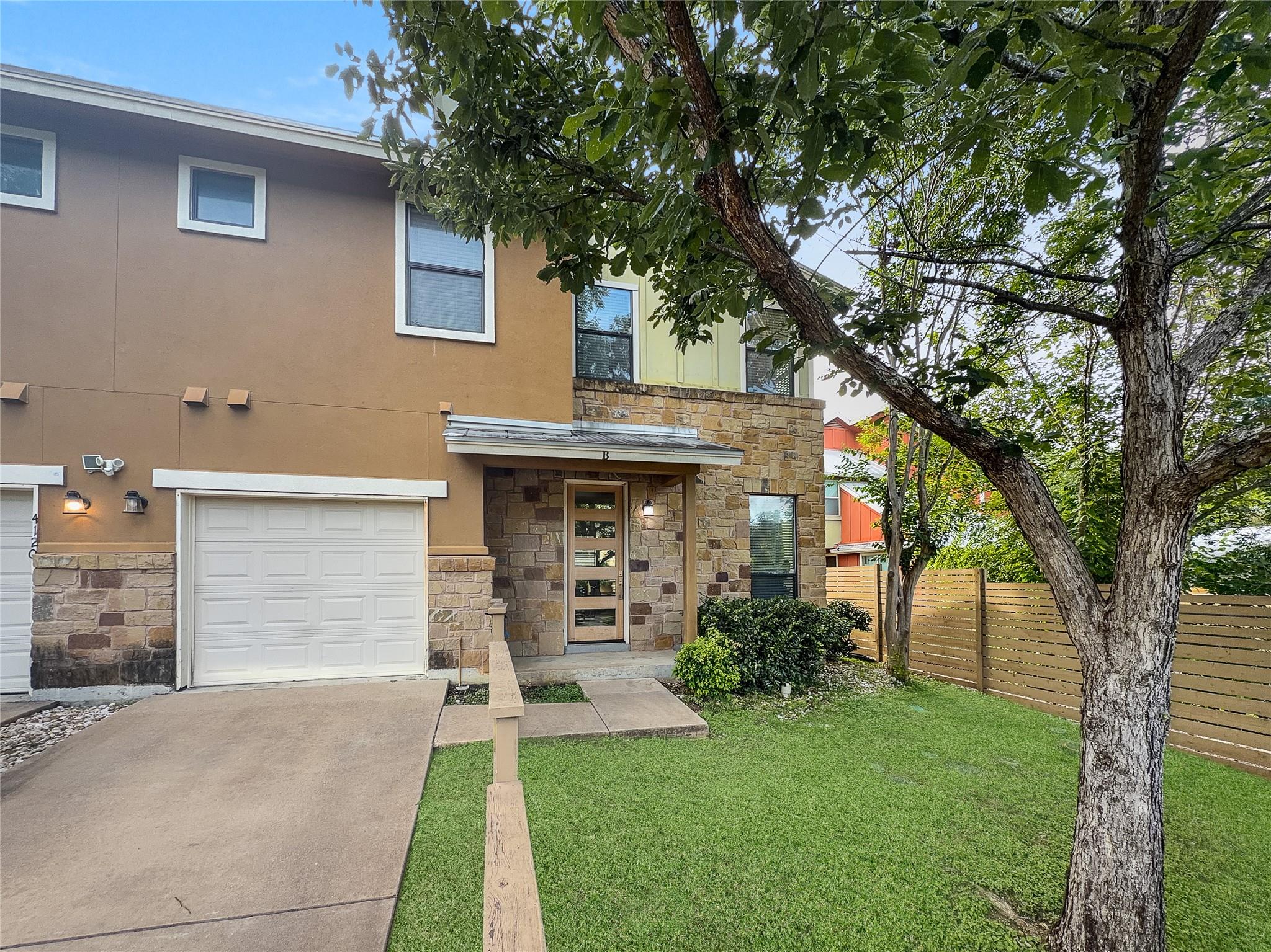 A well-maintained lawn and sturdy wooden fence en