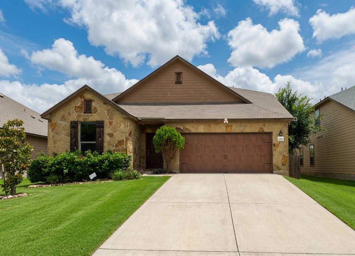 A classic stone facade and inviting driveway welc