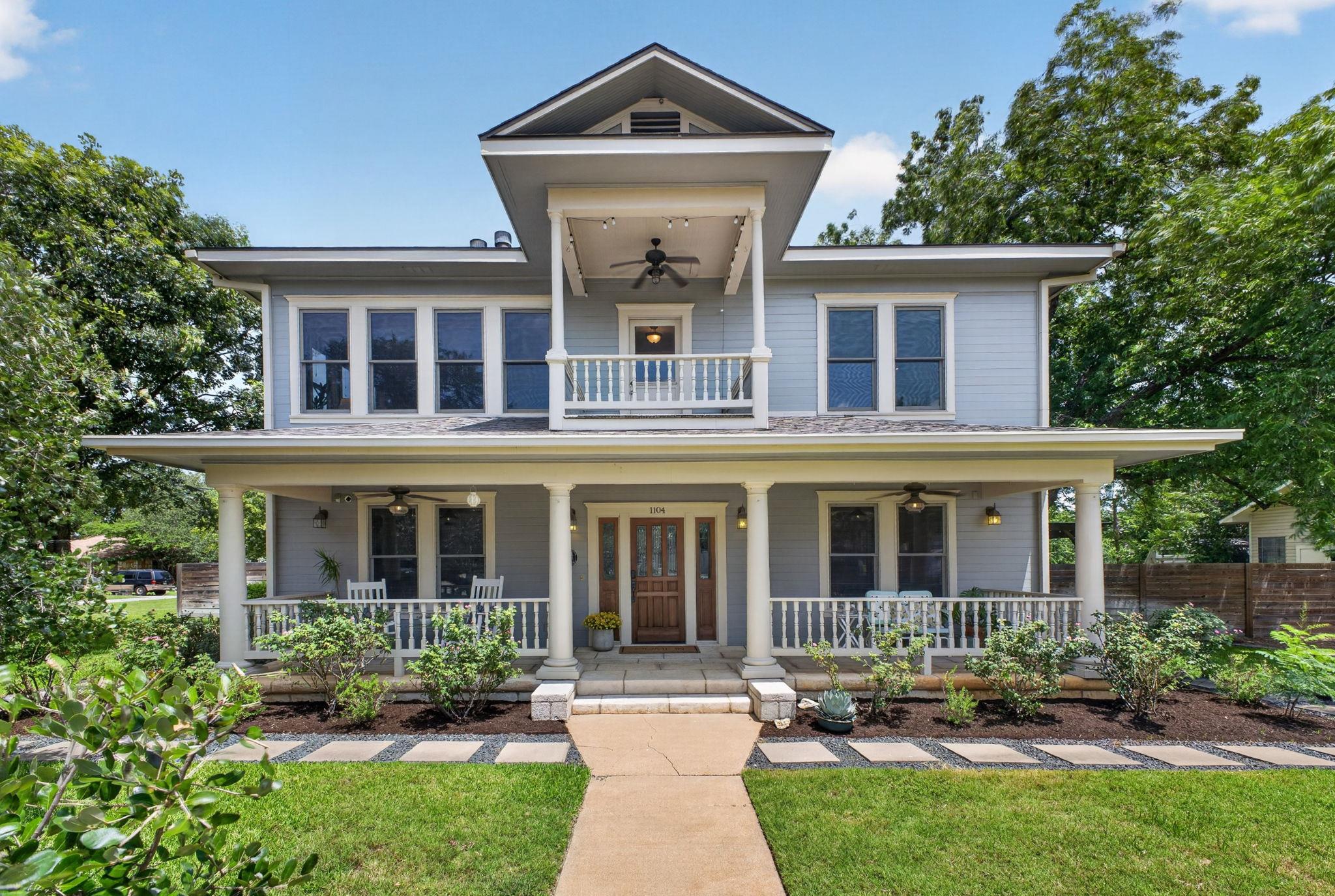 A classic facade with a welcoming porch and upper