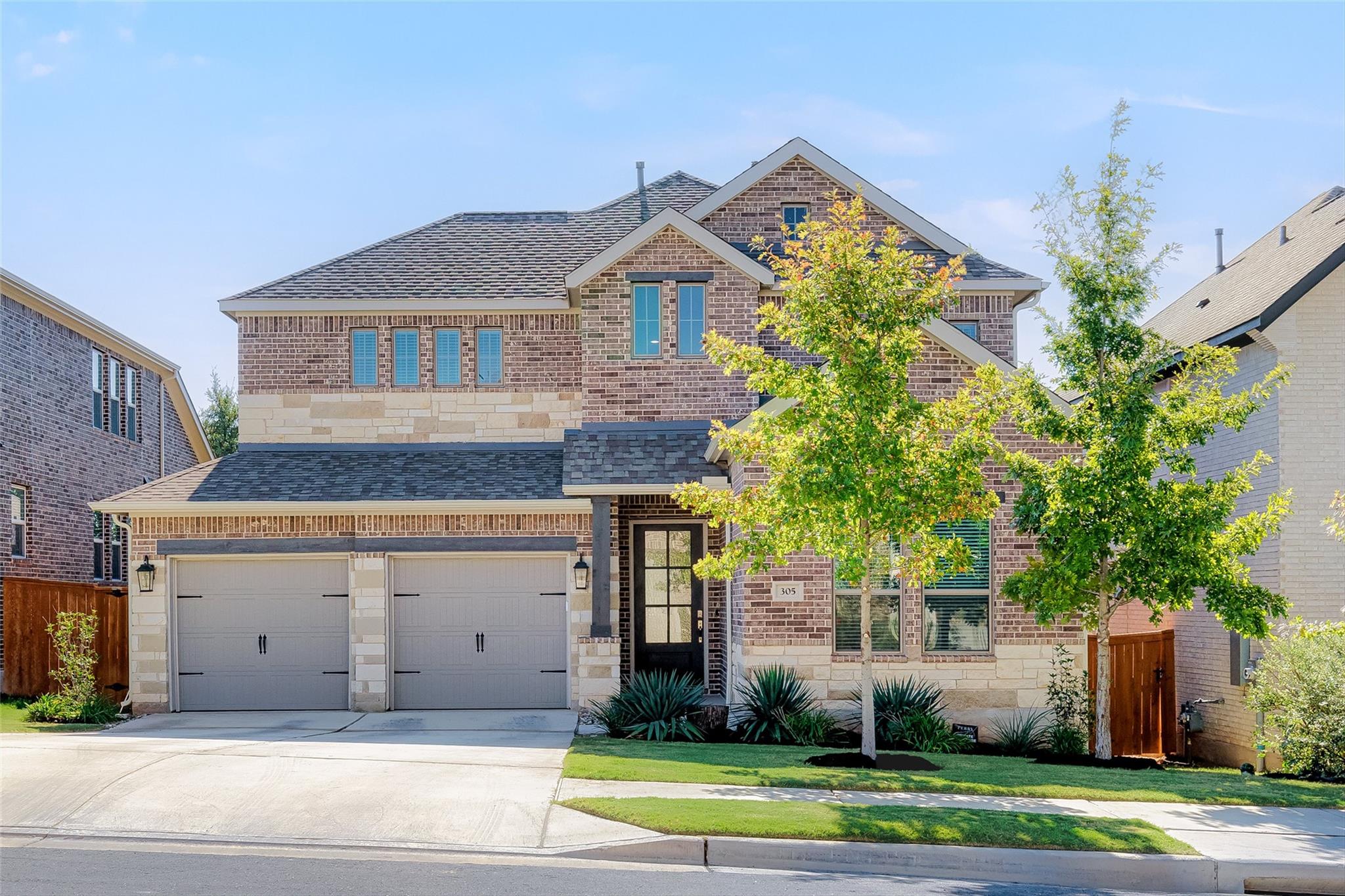 A classic brick and stone facade welcomes with an