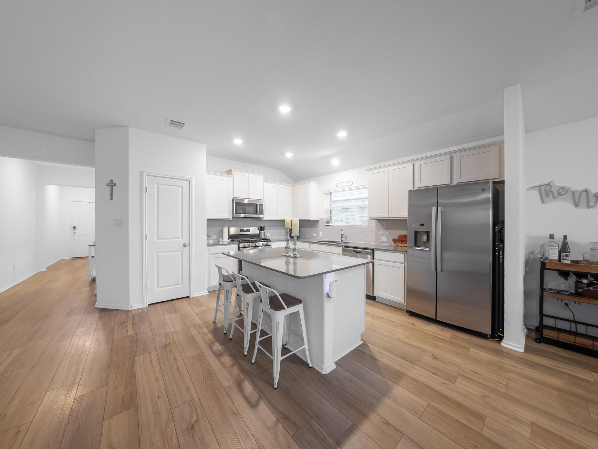 A well-lit kitchen with modern stainless steel ap