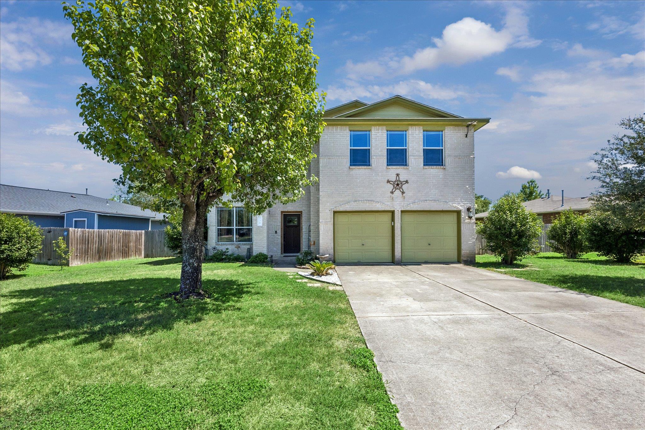 A classic brick exterior with a two-car garage aw