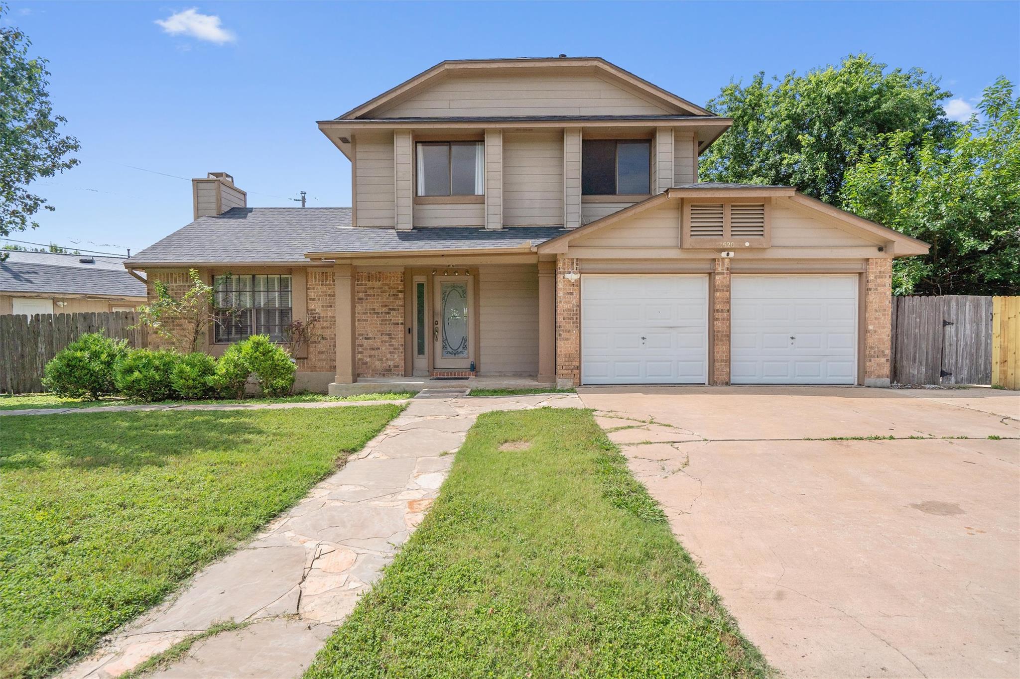 A well-kept front yard and brick accents offer in