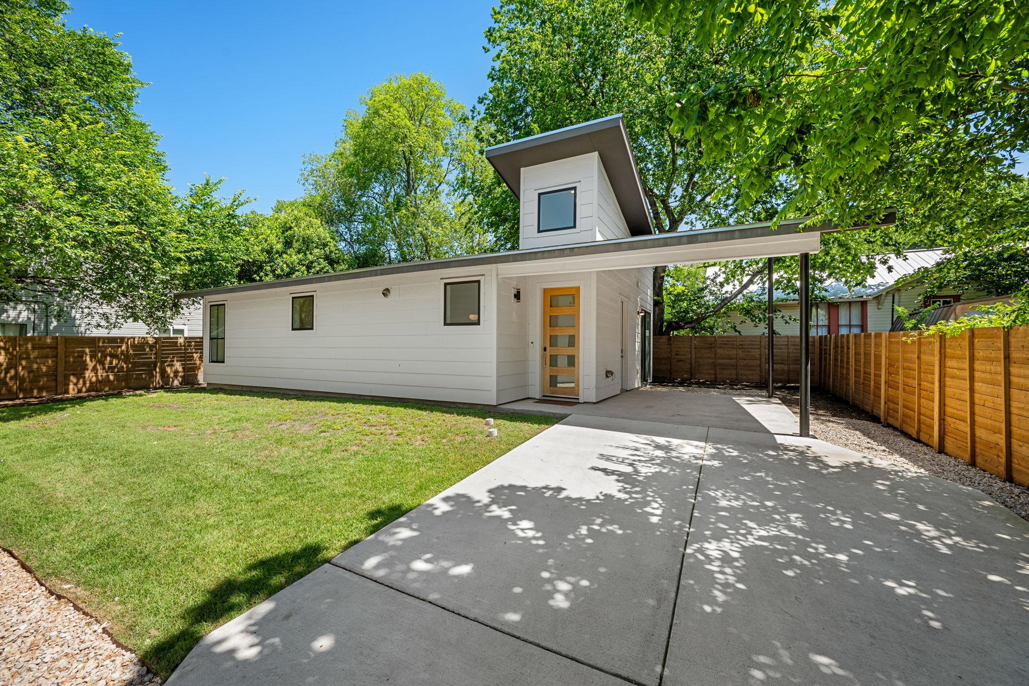 Modern home featuring clean lines, a covered carp