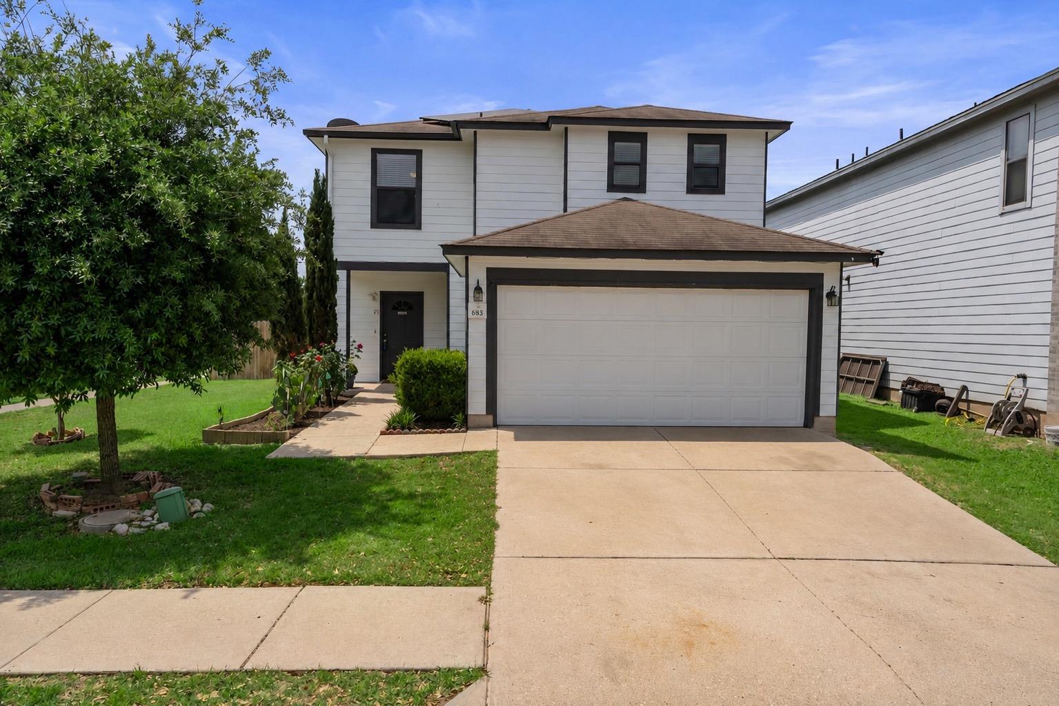 A classic two-story home with a pristine white ex