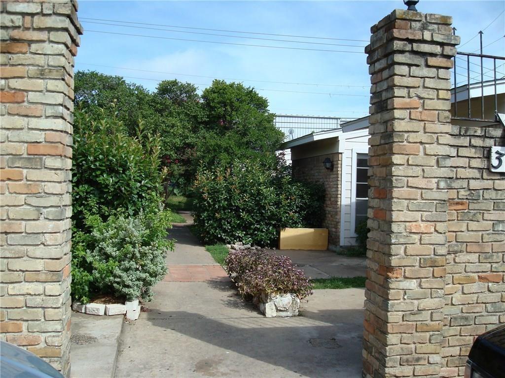A welcoming brick entryway invites you into a lus
