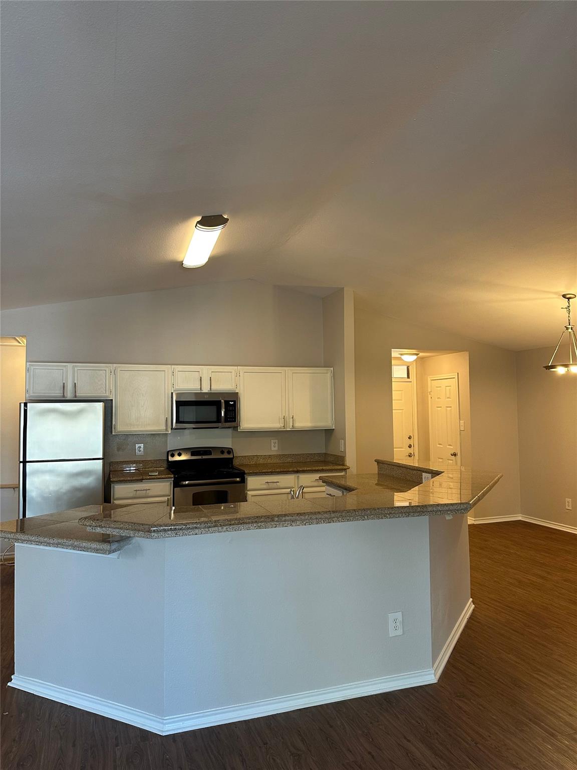An inviting kitchen features a breakfast bar with