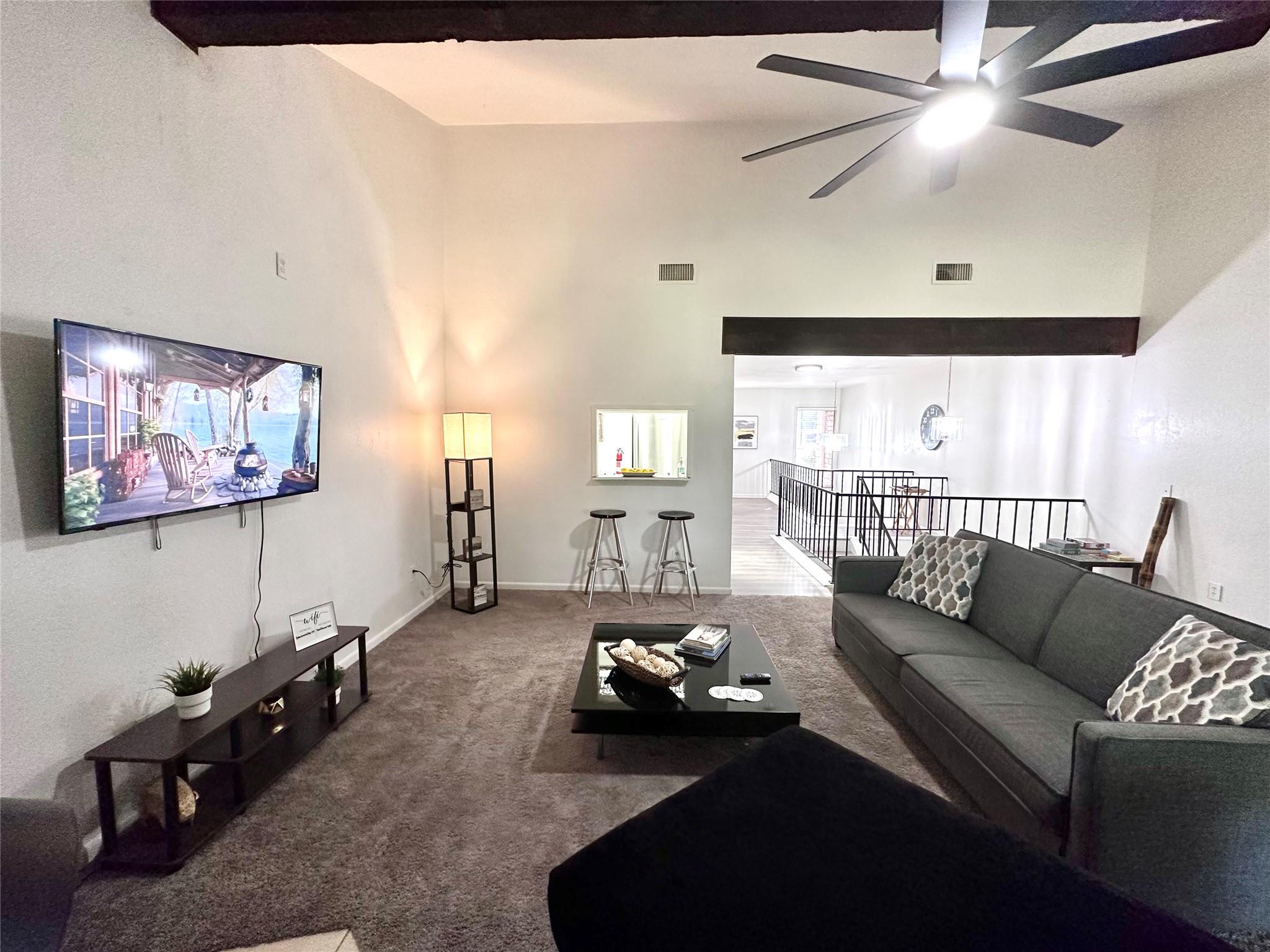 A spacious living room features soaring vaulted c