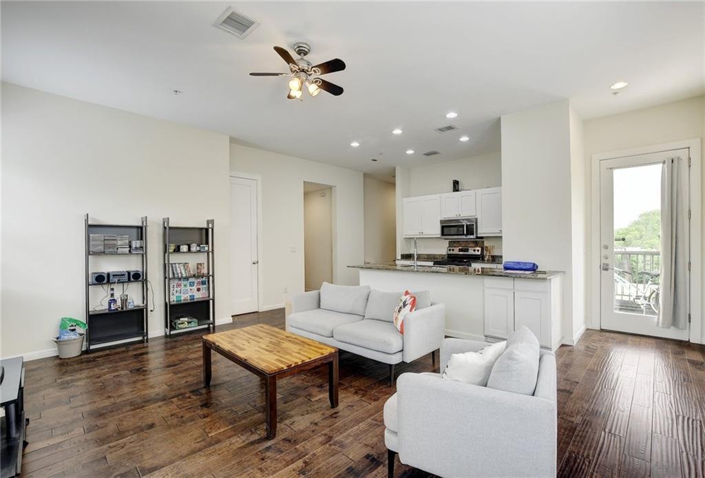 Rich hardwood flooring complements the open layou