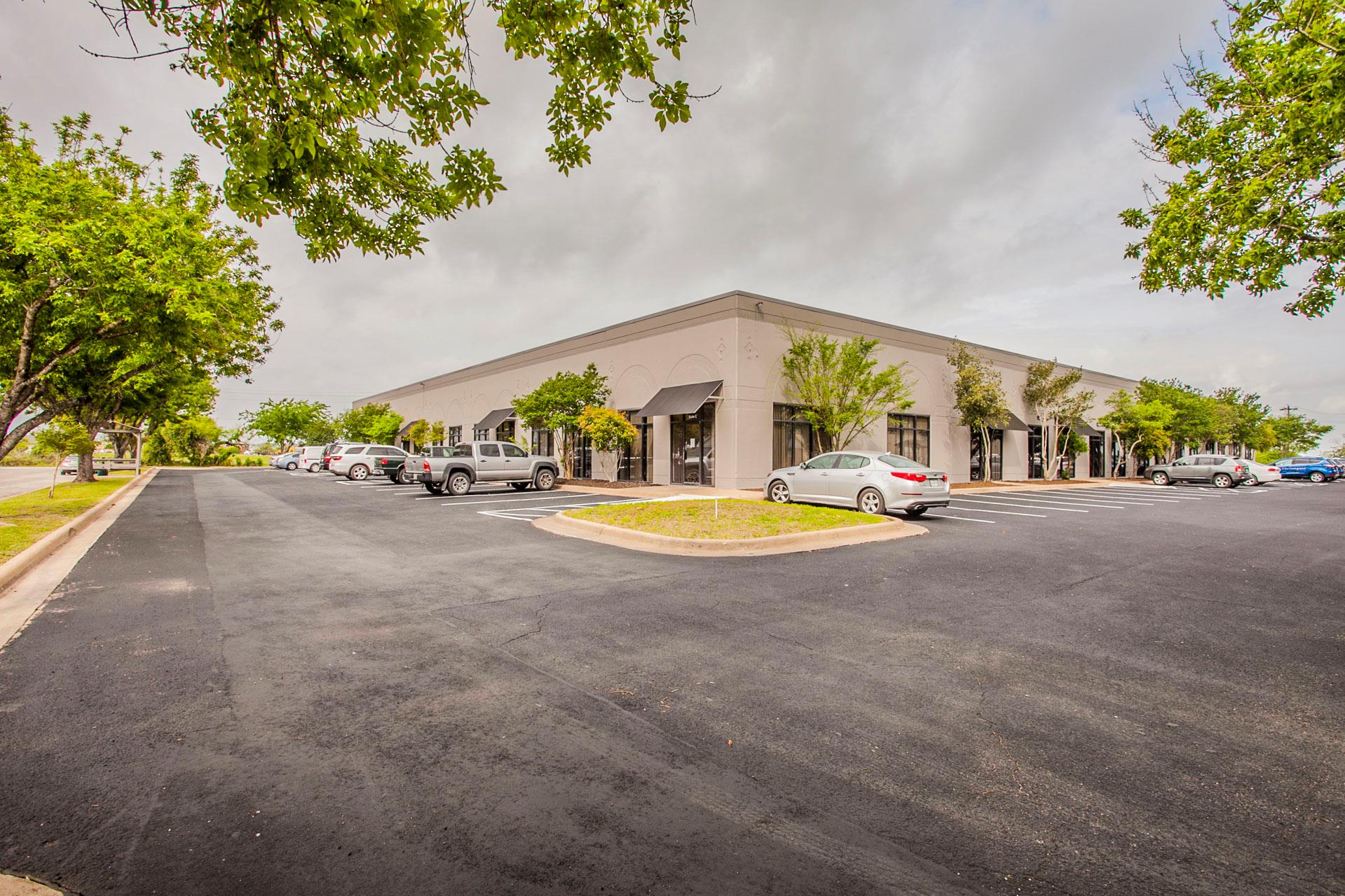 A corner commercial structure with awnings and am
