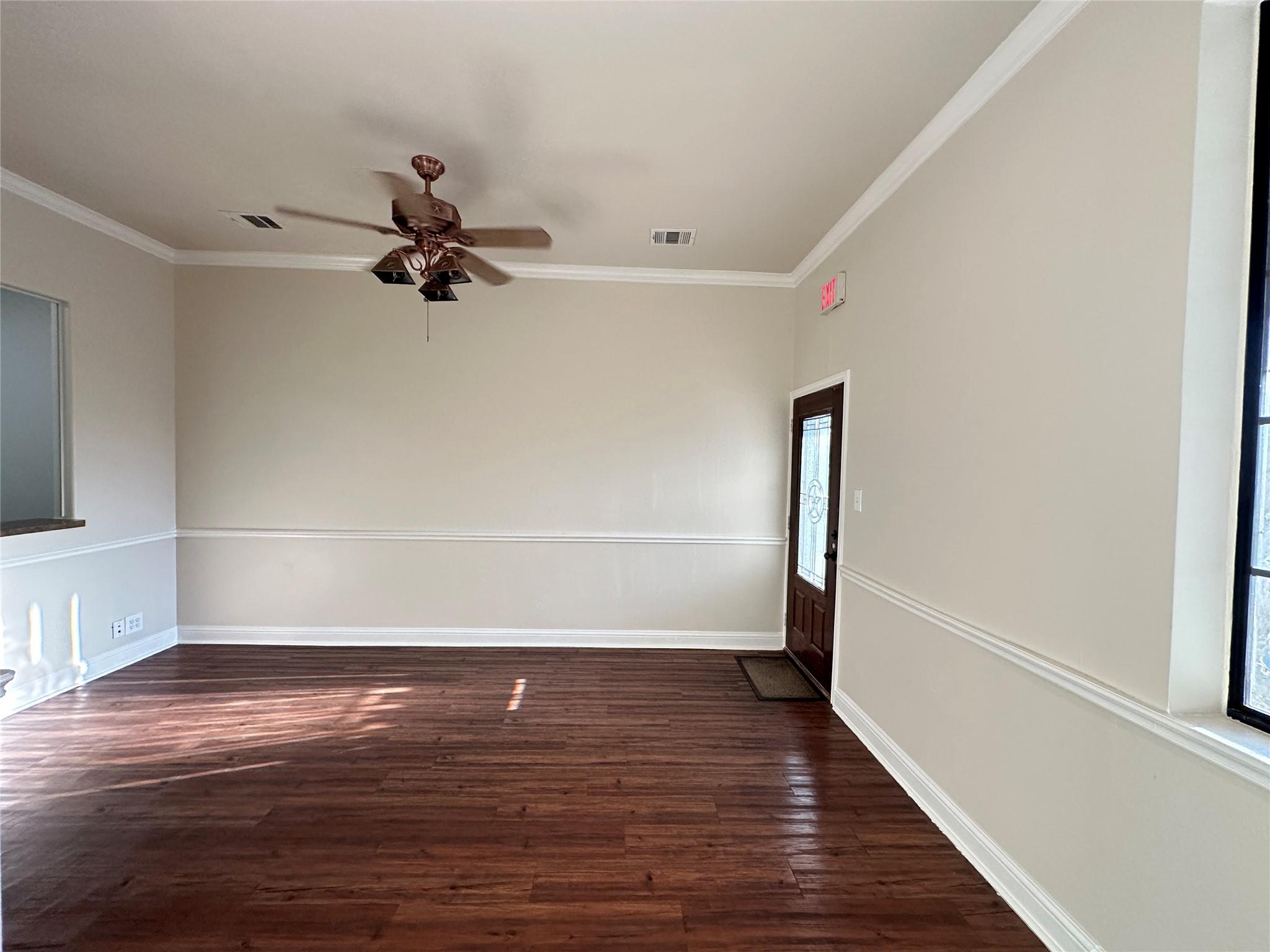Rich wood flooring complements a well-lit living 