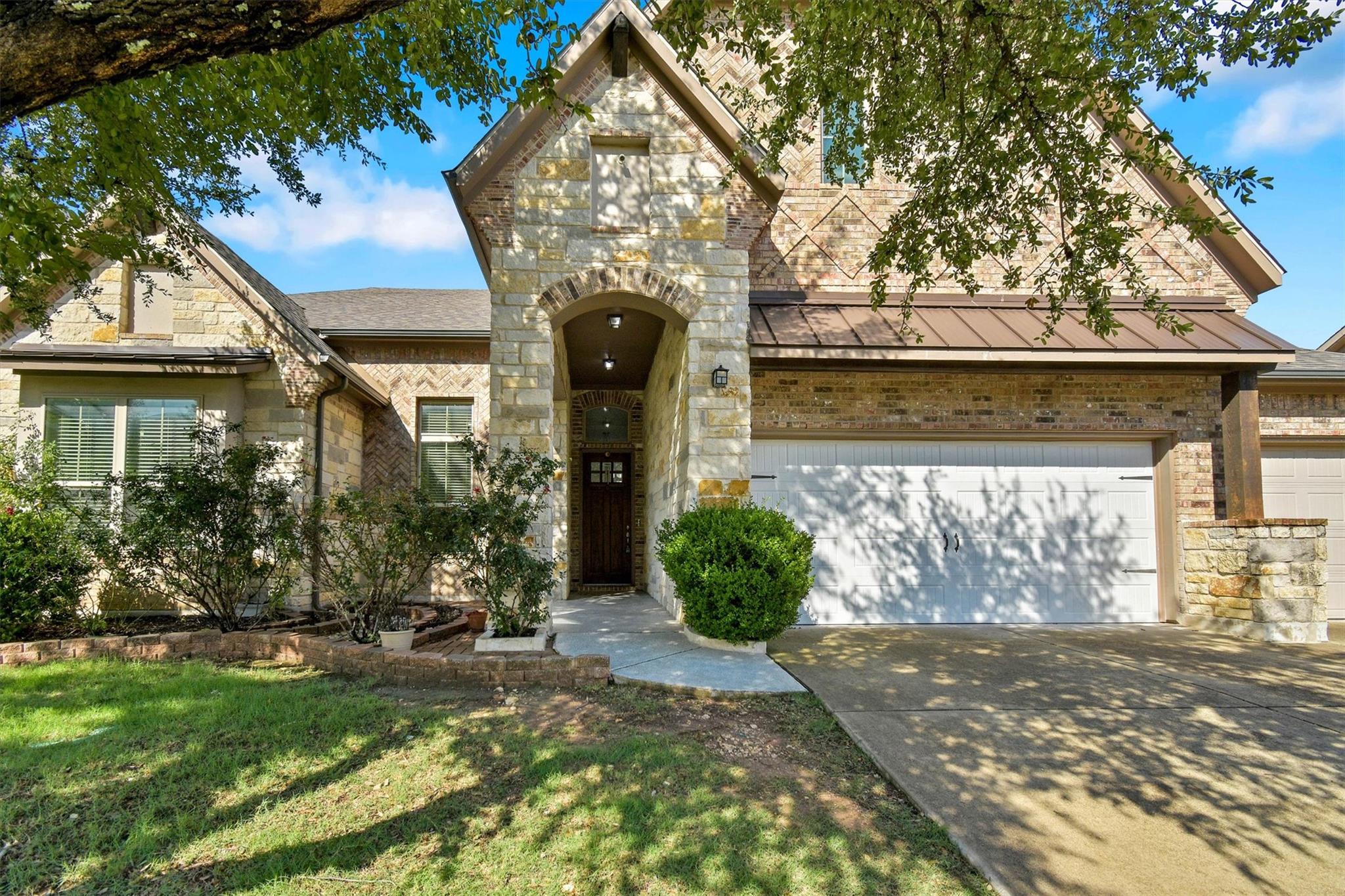 A striking exterior featuring a blend of stone an