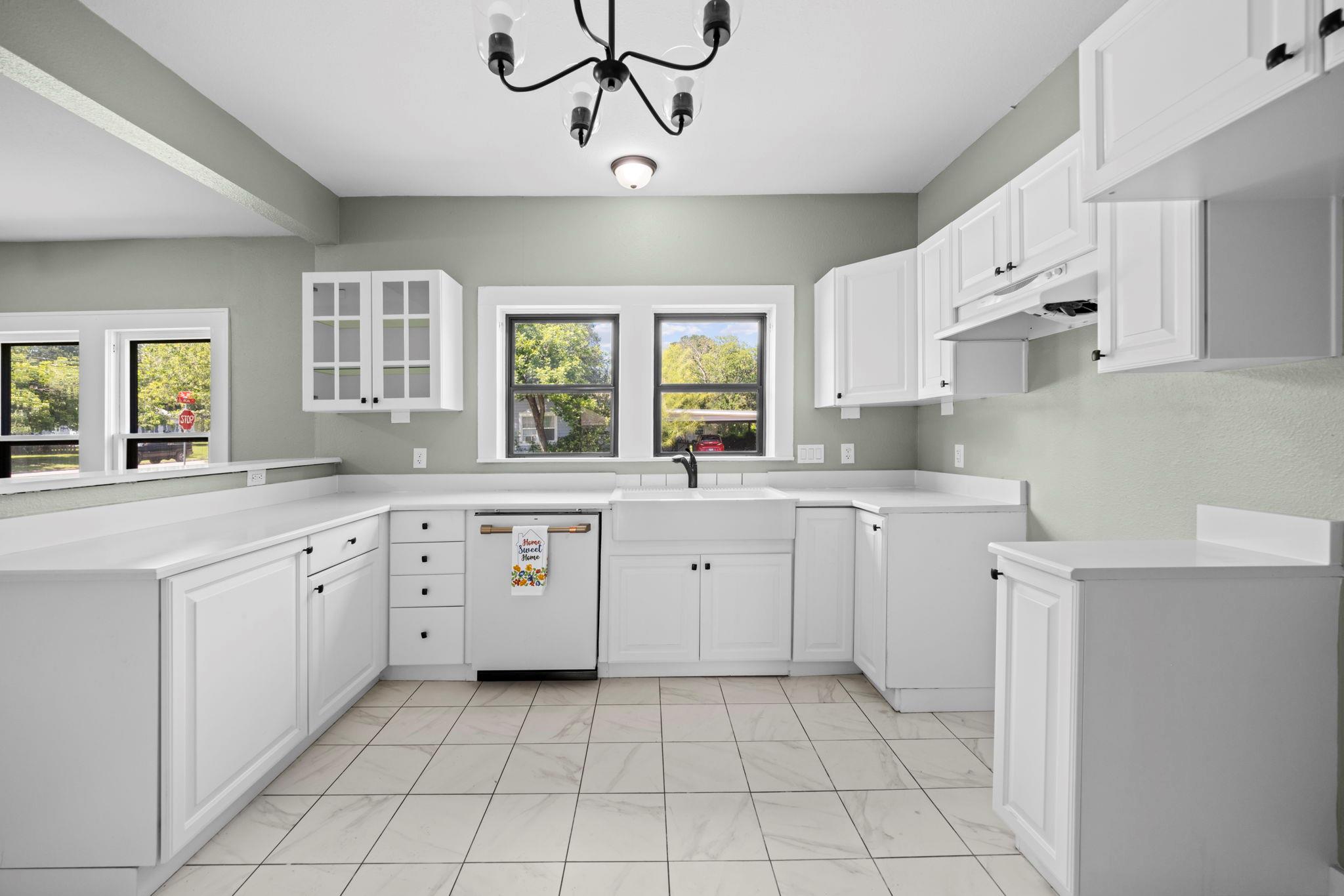 A well-lit kitchen presents a functional layout, 
