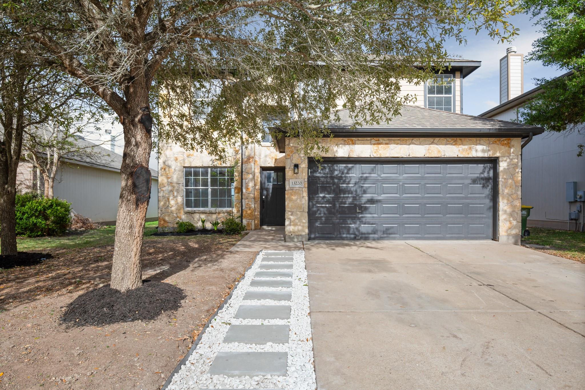 A stone facade welcomes you to this residence, fe