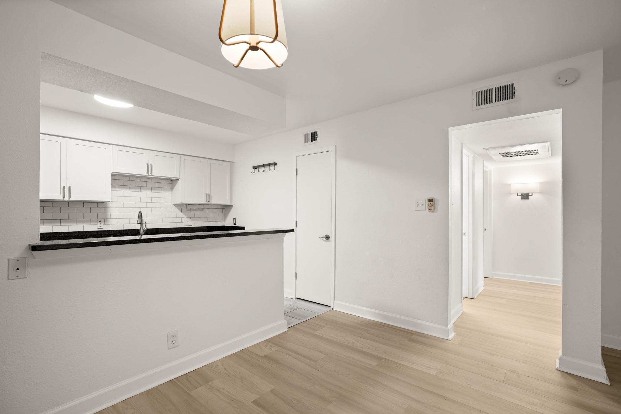 A sleek breakfast bar and subway tile backsplash 