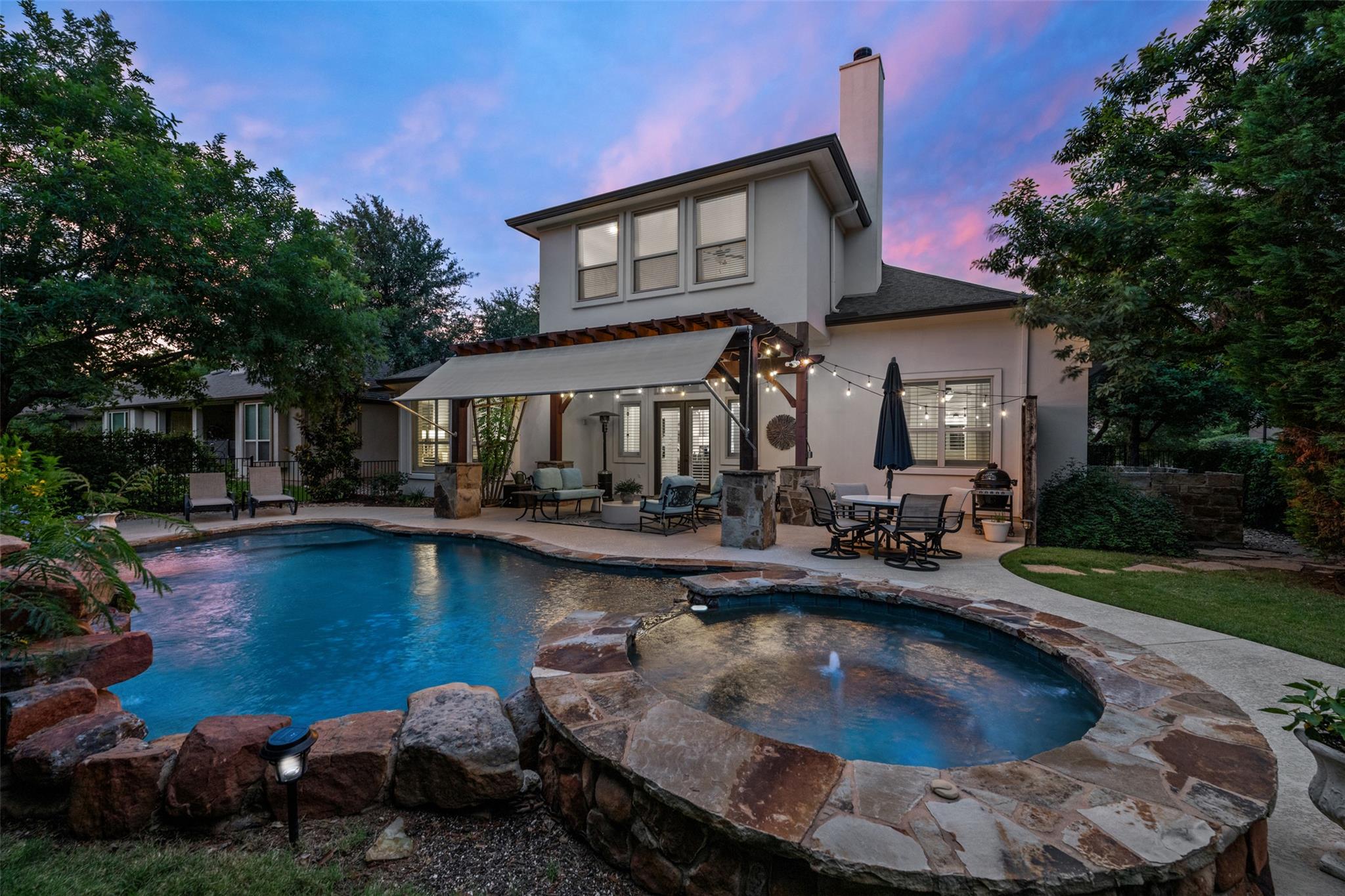 A private backyard oasis showcases a sparkling po