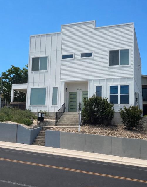 Clean lines and multi-textured siding define this
